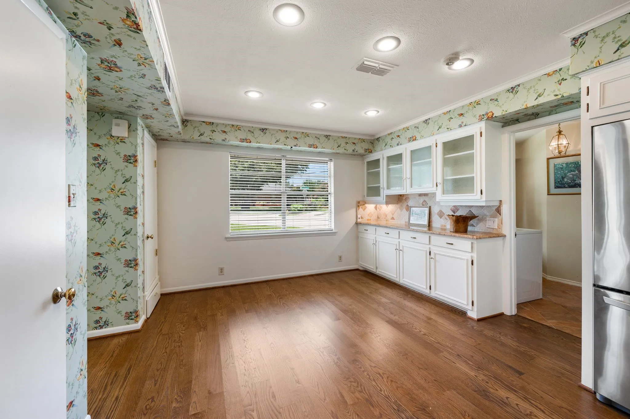 Love the bird motif wallpaper and solid oak floors