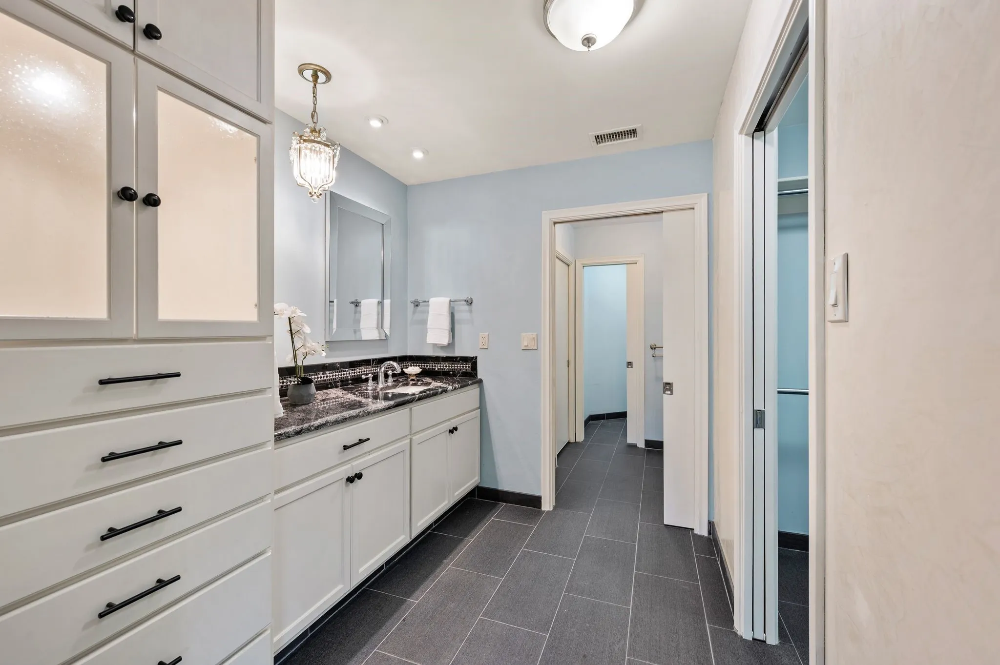 Spacious primary bath features black exotic marble