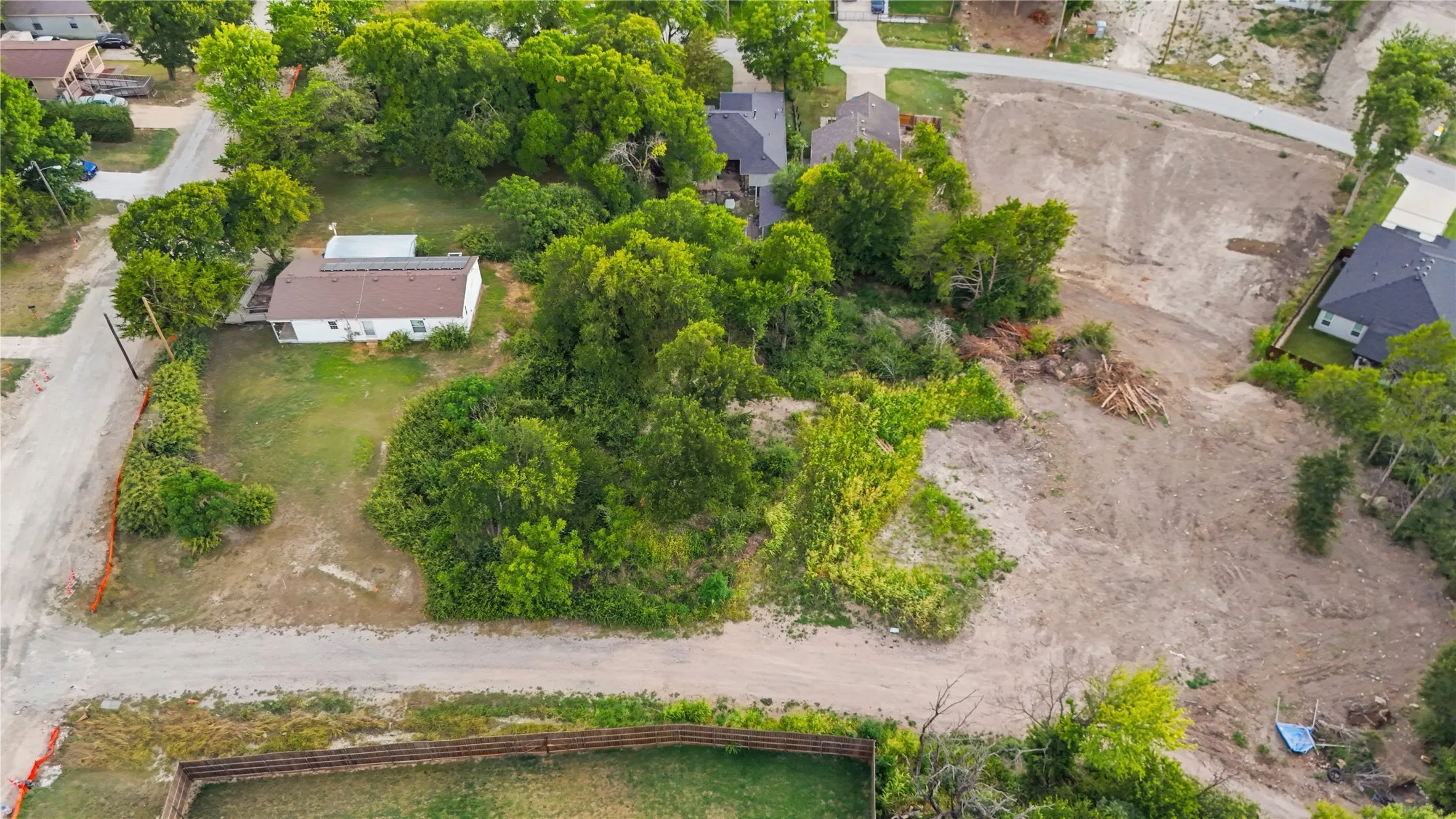 Expansive undeveloped lot featuring substantial cleared areas and mature trees