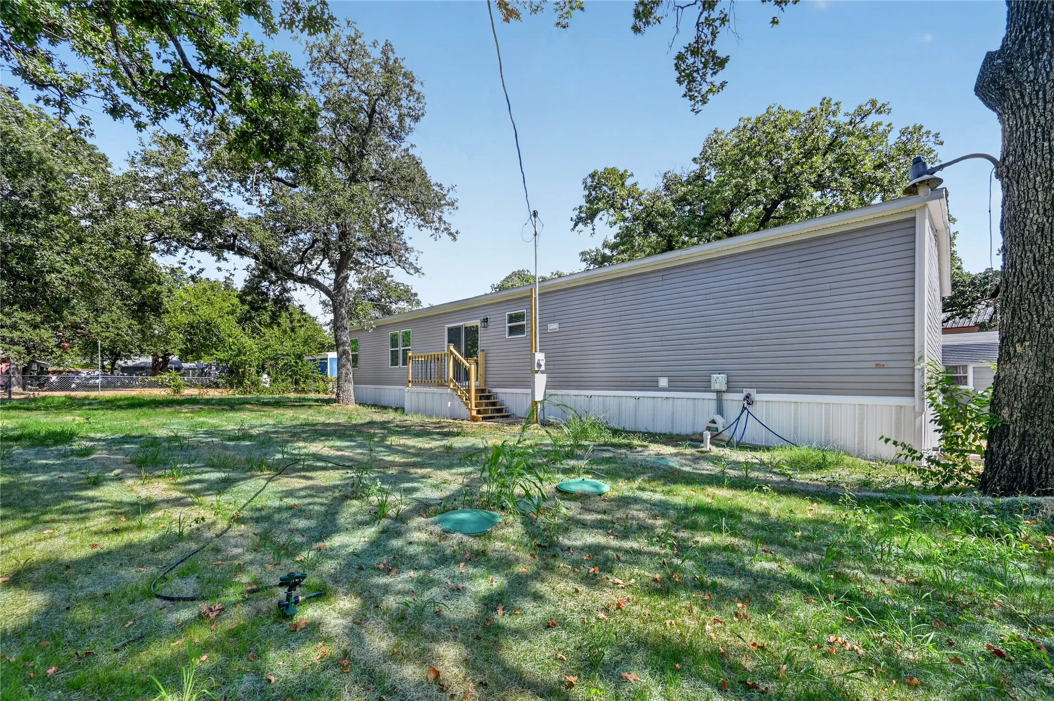 Gray horizontal siding with white trim and a wooden deck