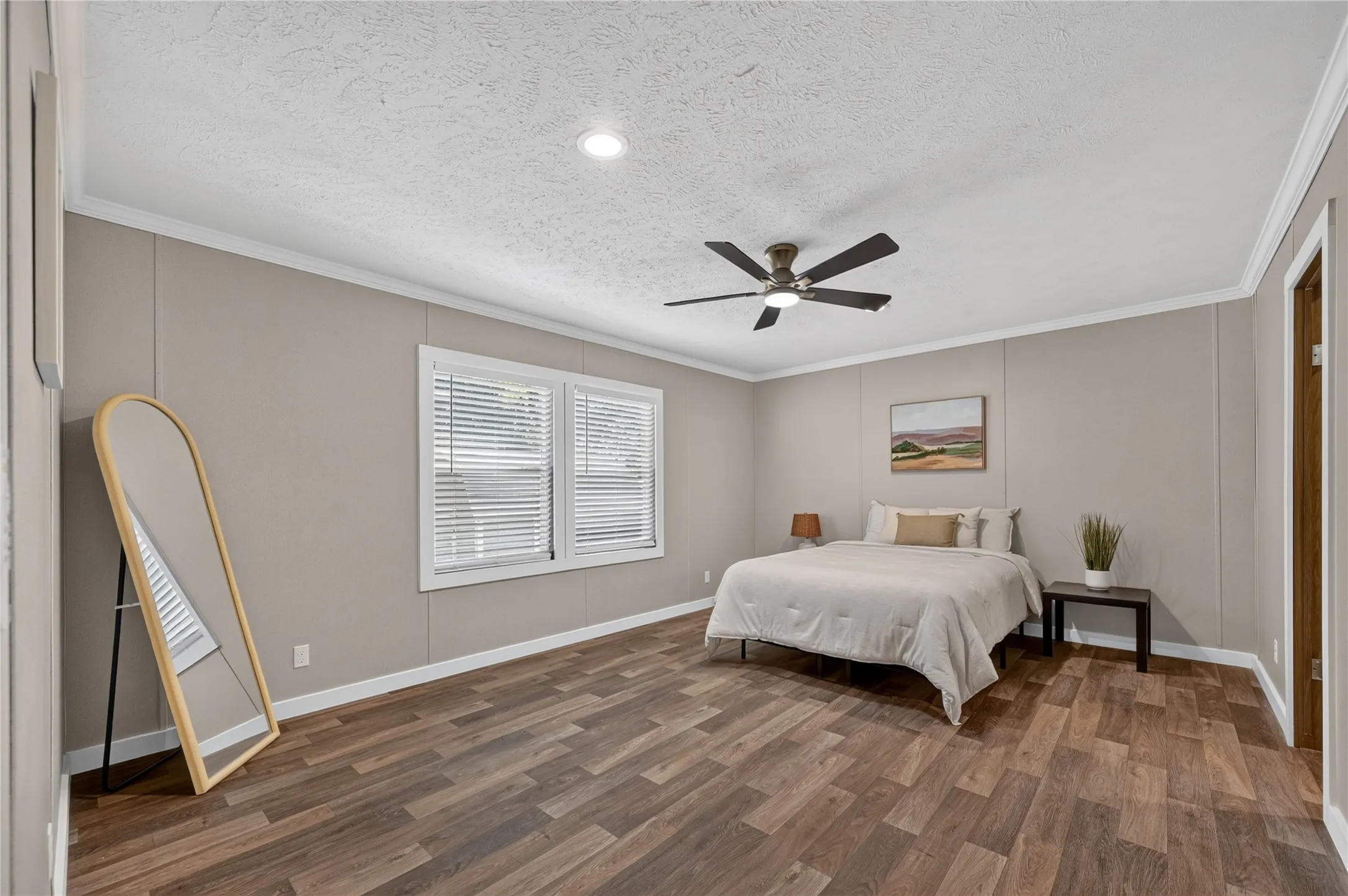 Wood-finish flooring, recessed lighting, ceiling fan with integrated light, window with blinds, and white trim