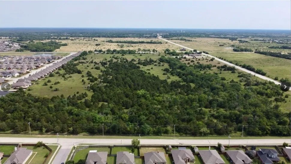 Expansive undeveloped land featuring mature trees and open clearings