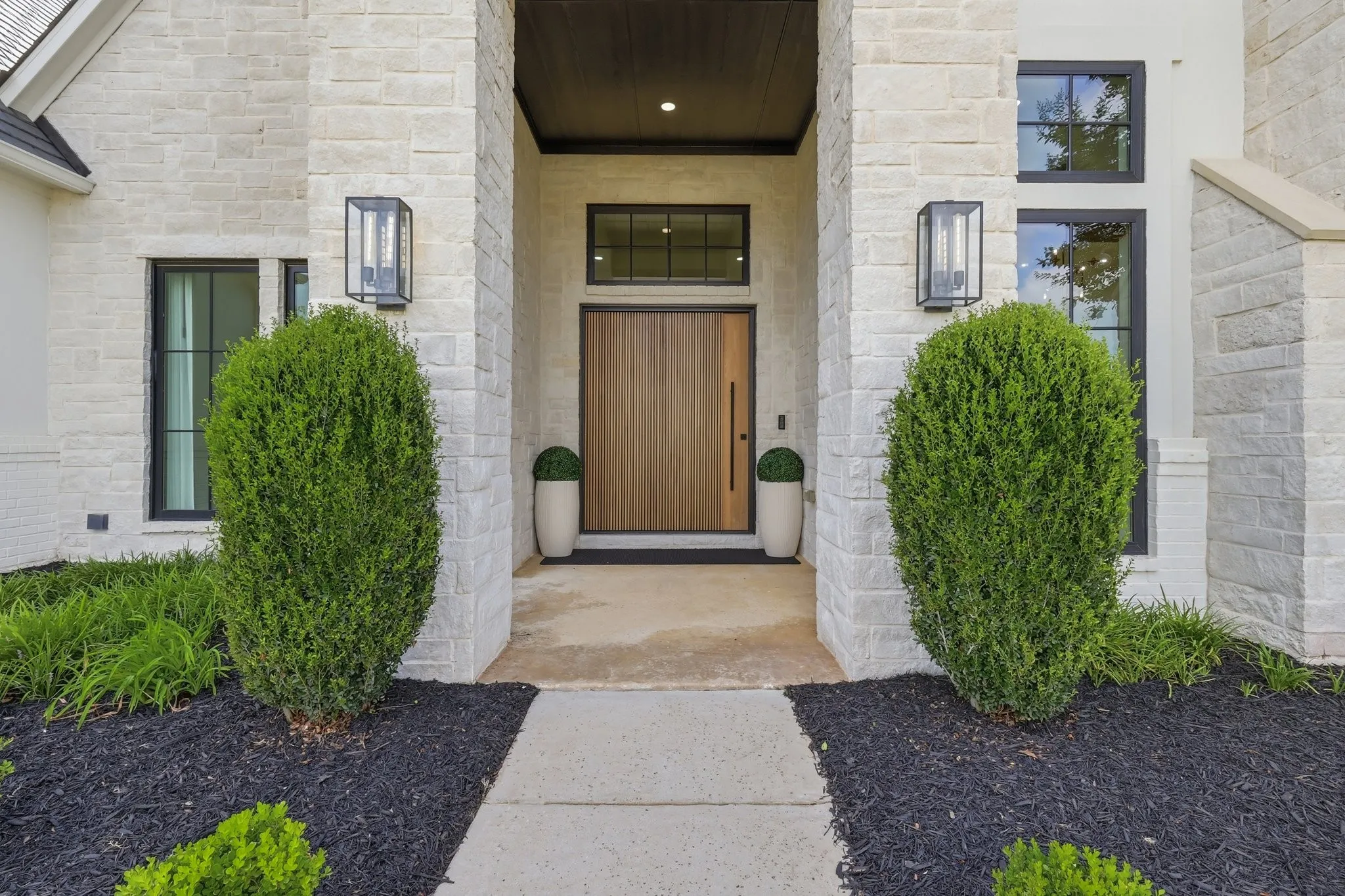 Greeted by a stunning custom-crafted 6-foot-wide steel-core, R7-insulated pivot front door featuring premium solid painted wood construction, handcrafted in Colorado.