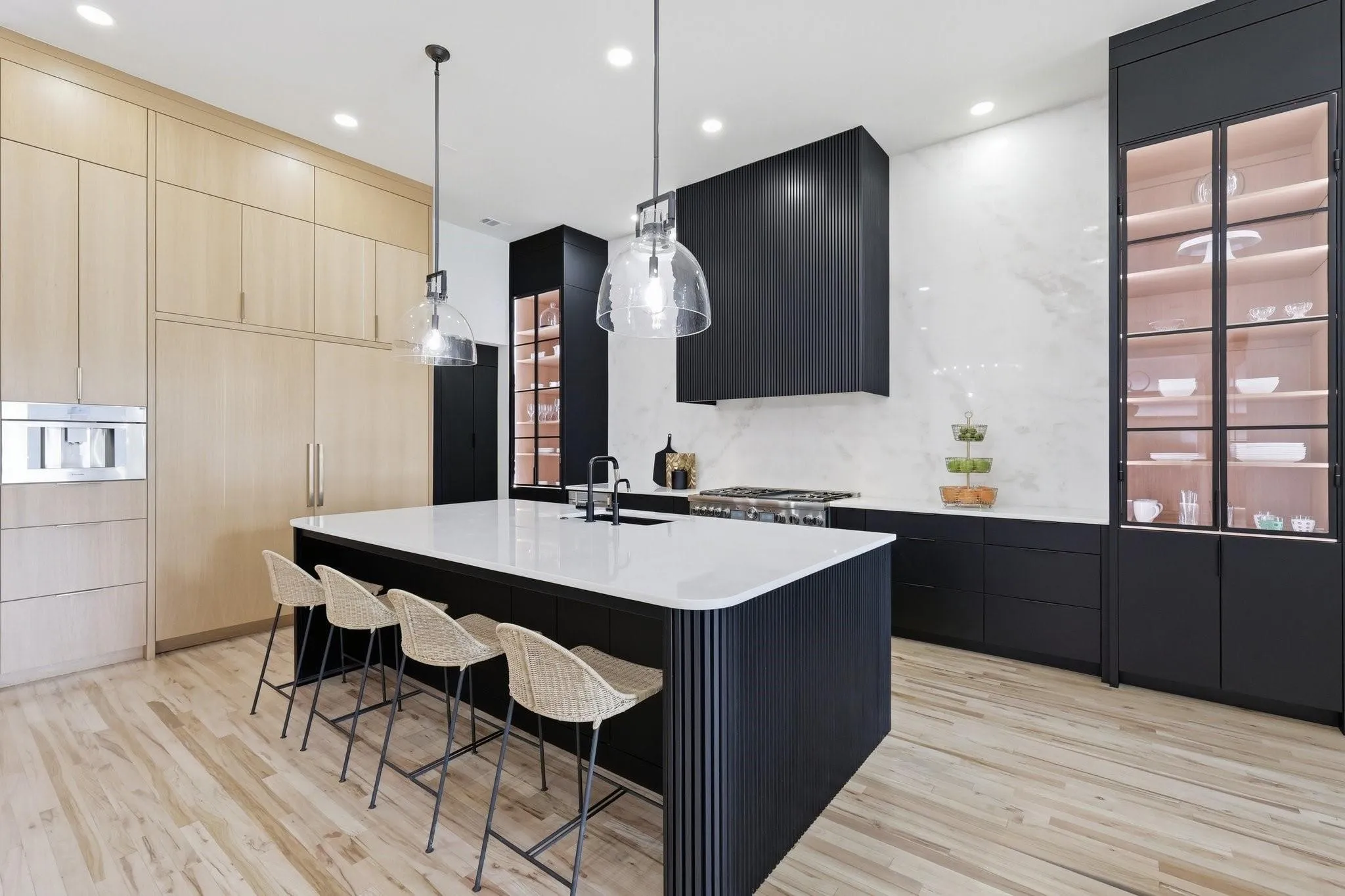 The premium Thermador Professional appliance package includes 36-inch refrigerator and freezer columns, a commercial-grade gas range, double ovens, a built-in microwave, and dual dishwashers. A built-in Thermador plumbed coffee station further elevates the Kitchen's exceptional functionality and luxury.