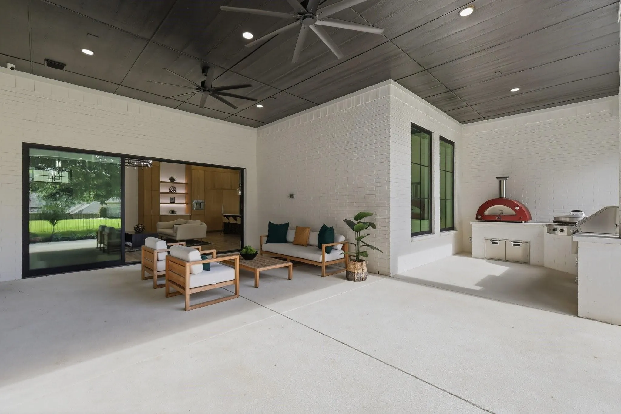 This expansive Covered Outdoor Living Area is finished with a rich wood ceiling and dual oversized ceiling fans—comfortable year-round.
