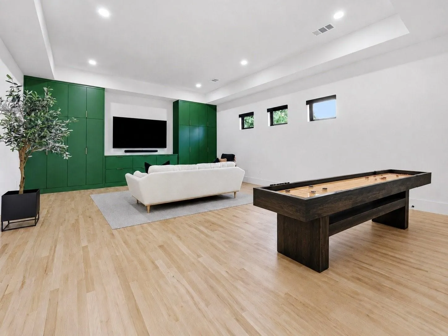 The versatile Media/Game Room is designed for play or the perfect movie-night atmosphere, featuring motorized blinds, a Sonos TV and sound system, custom built-ins, and a dedicated media closet.
