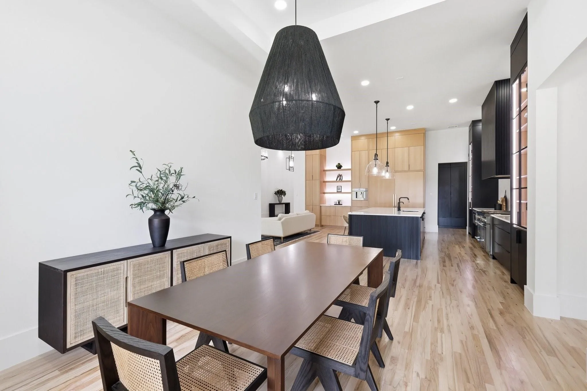 The Dining Room flows seamlessly into the Kitchen and Living Room, creating an open-concept layout ideal for entertaining.
