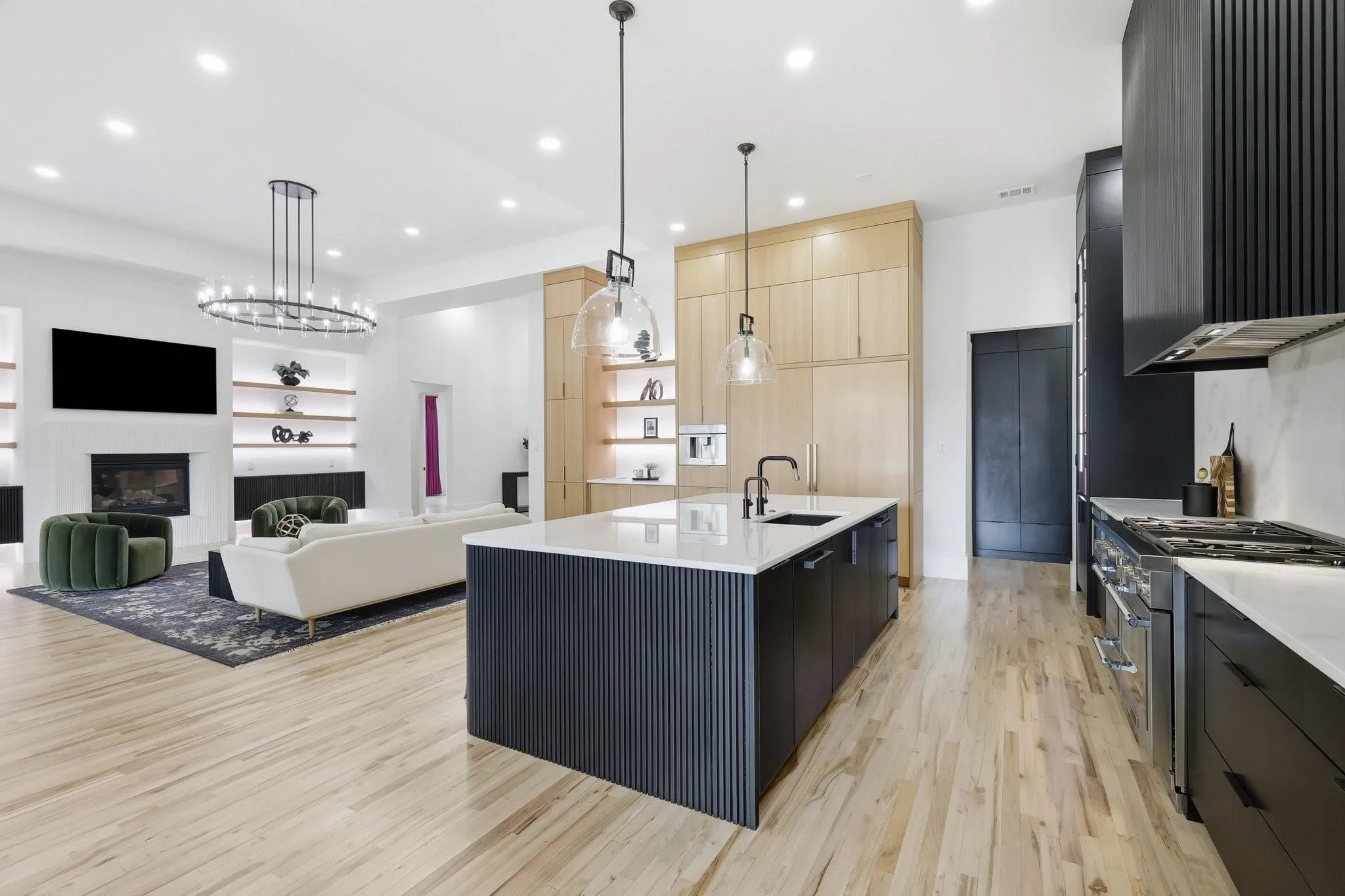 The custom rift-cut white oak cabinetry wall has a built-in Thermador coffeemaker, a 36-inch refrigerator/freezer, and ample storage.
