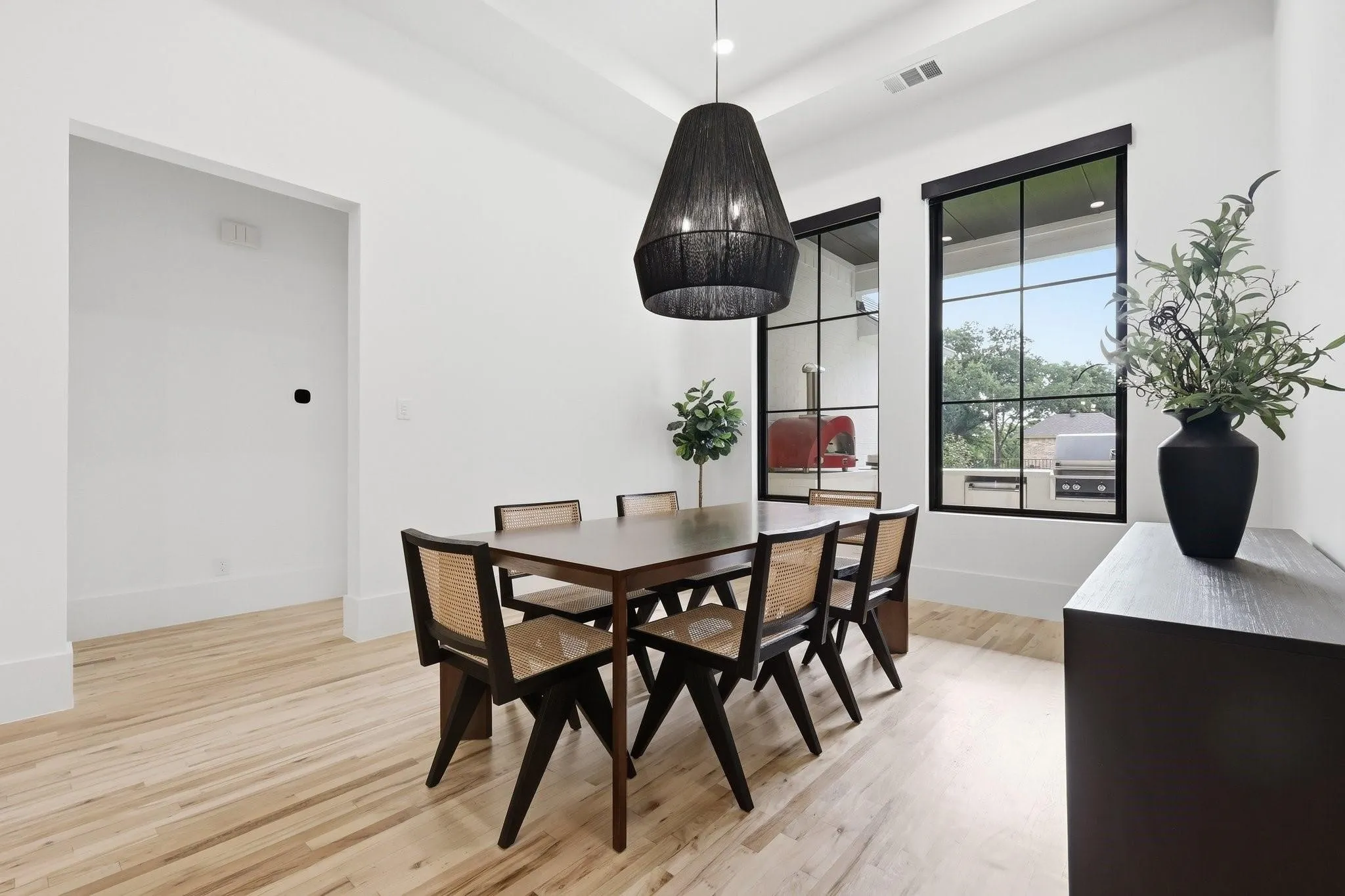 The oversized Dining Area features automated shades and designer Restoration Hardware lighting, adding both convenience and elevated style.
