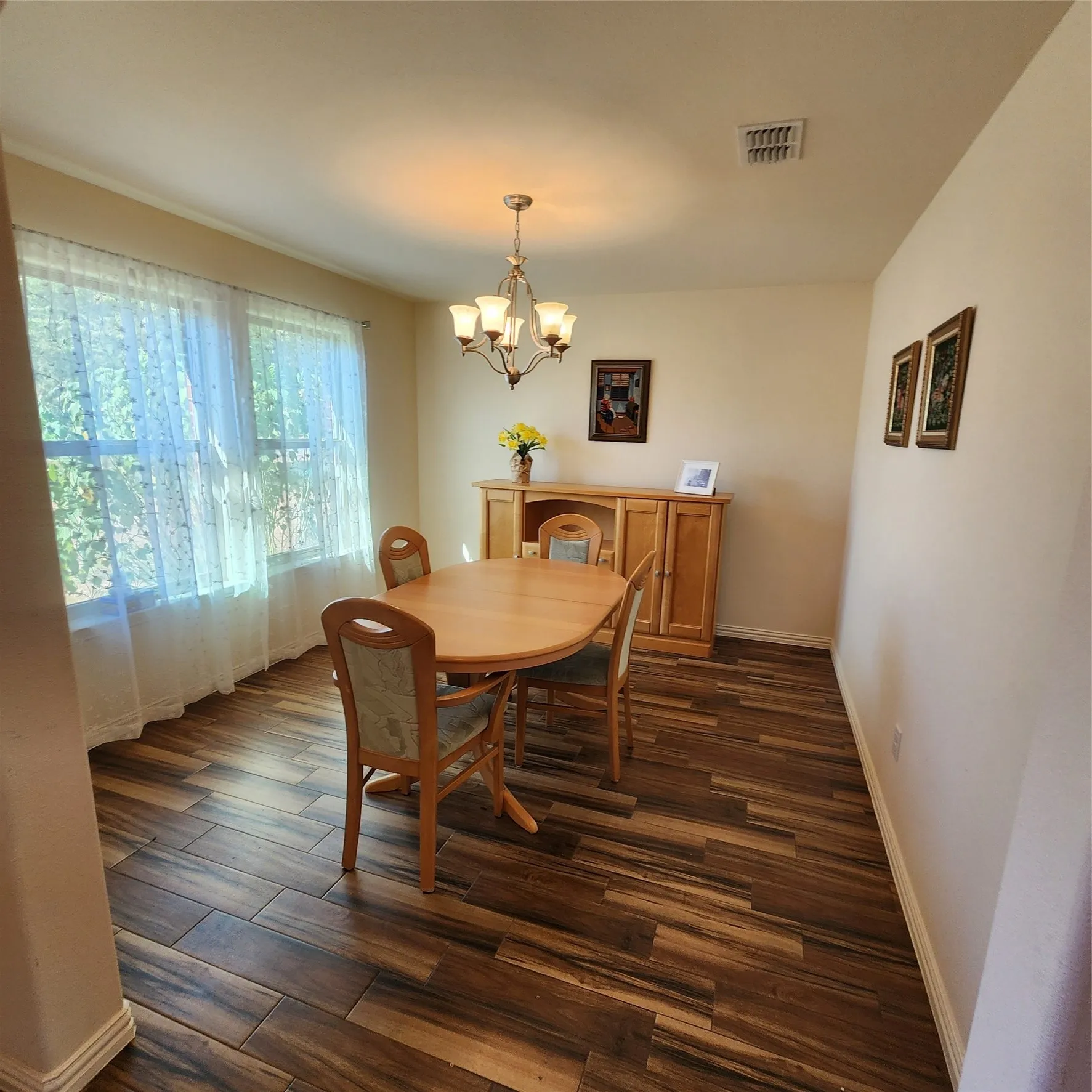 Wood-finish flooring, recessed lighting, and a multi-pane window with natural light