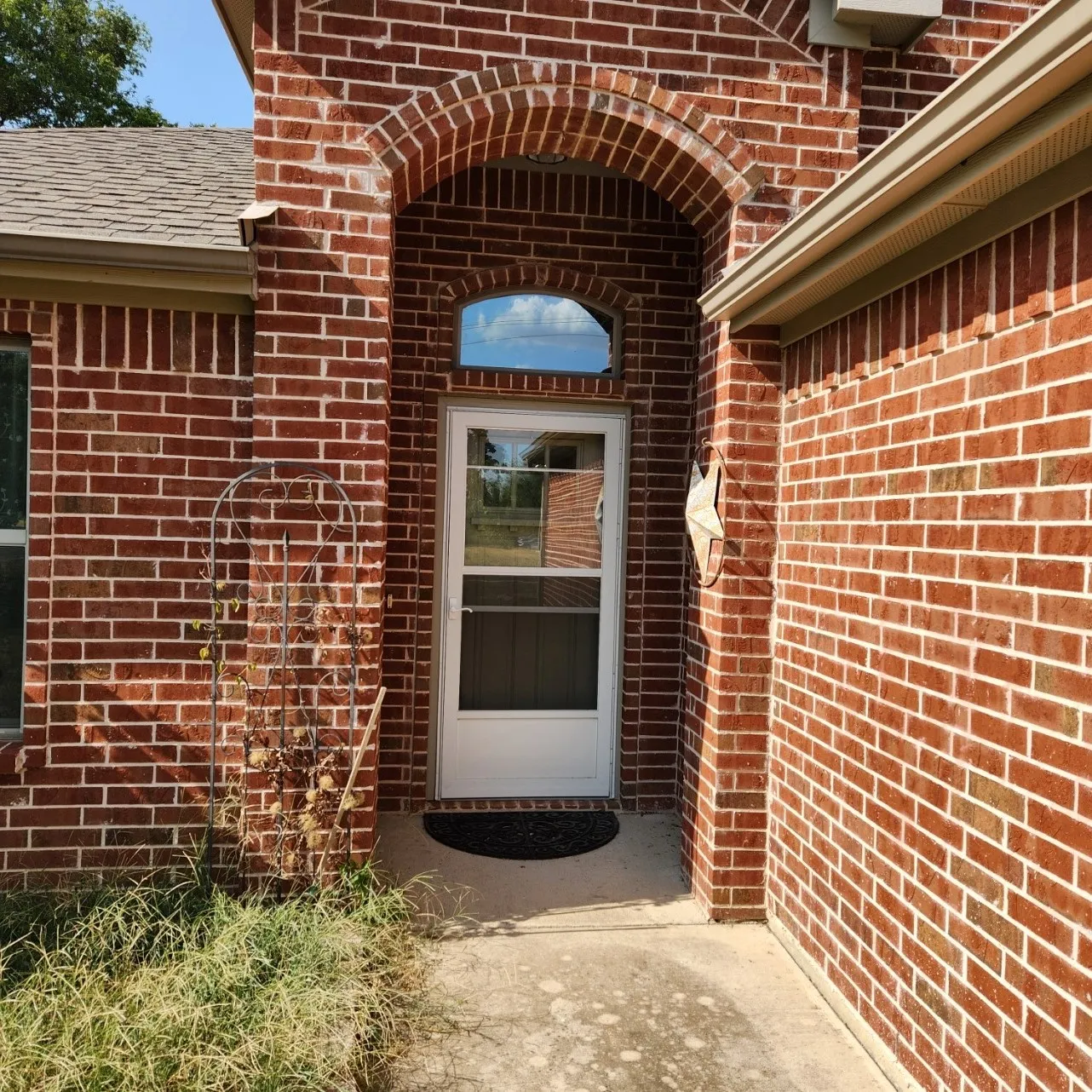 Red brick exterior with an arched entry