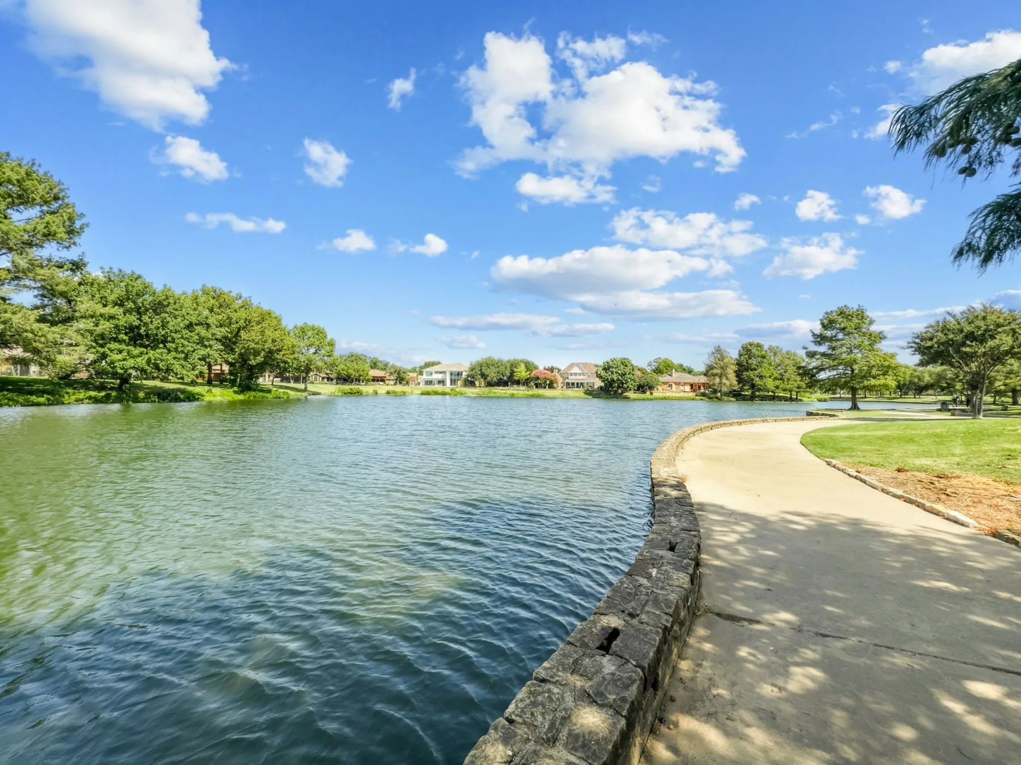 pond with walking trails, benches and bench swings