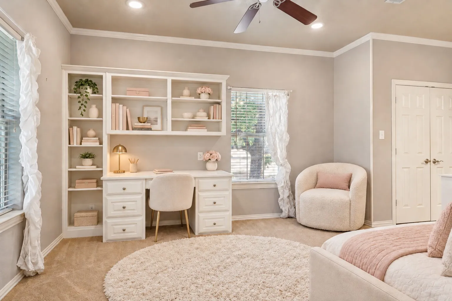 Built-in desk with integrated shelving, crown molding, double-panel doors, recessed lighting, and a ceiling​​‌​​​​‌​​‌‌​‌‌​​​‌‌​‌​‌​‌​​​‌​​ fan
