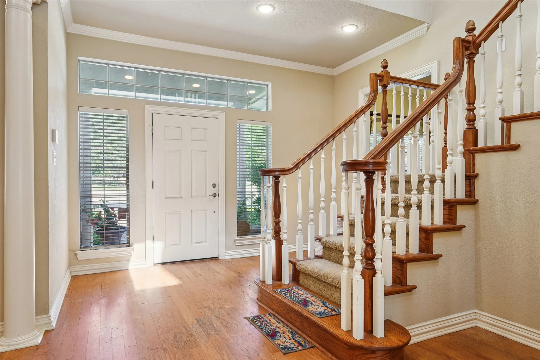 Hardwood flooring, turned wood balusters, recessed lighting, crown molding, and transom windows