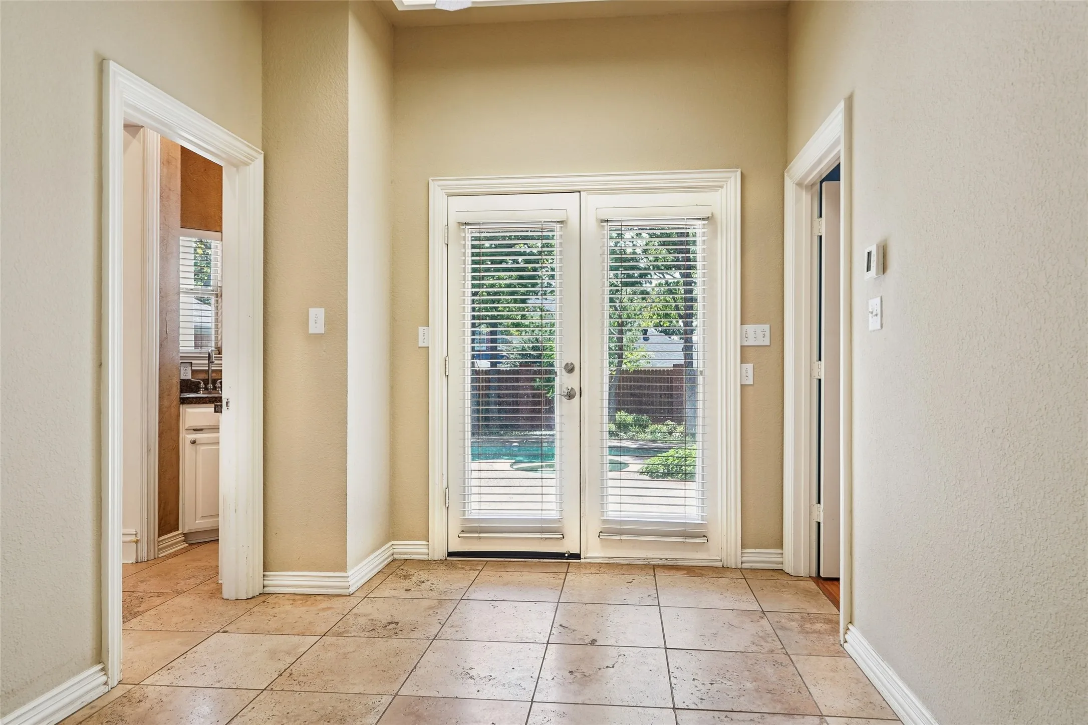 Tiled flooring, French doors, and recessed lighting