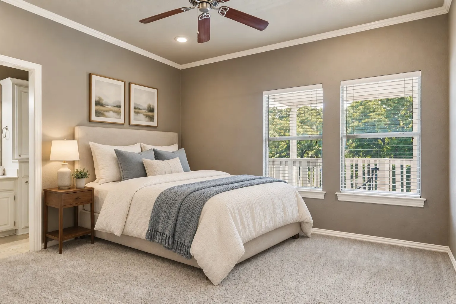 Plush carpet flooring, crown molding, a ceiling fan with integrated lighting, and two large windows with blinds