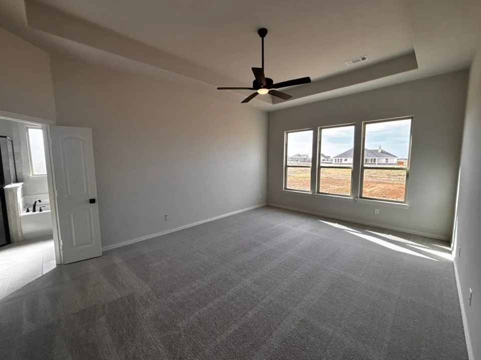 Recessed tray ceiling with a dark-tone ceiling fan
