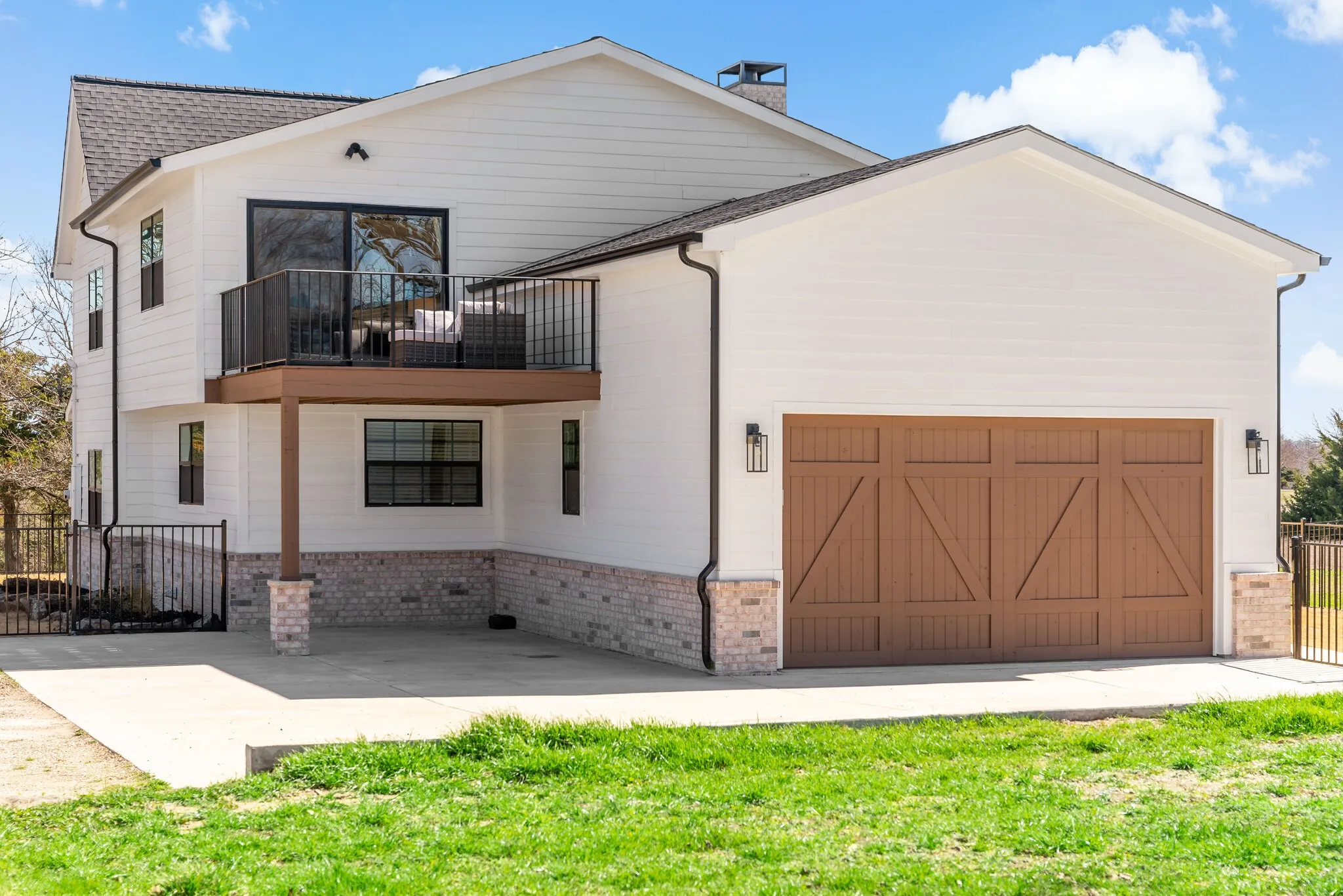 Facing the back of the home, you see the 2 car garage, both the balcony and the porch.