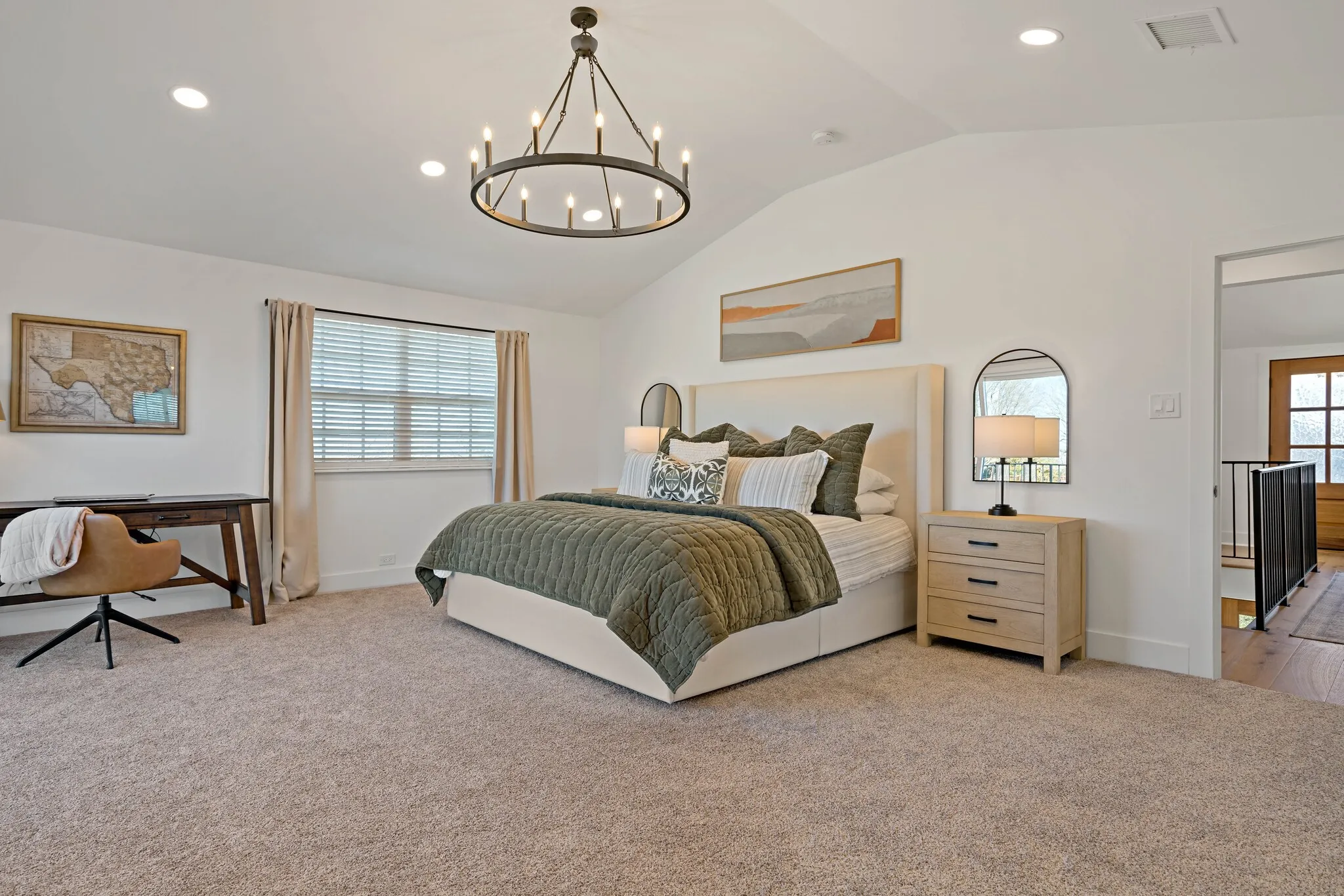Vaulted ceilings, recessed lighting, and a contemporary circular chandelier