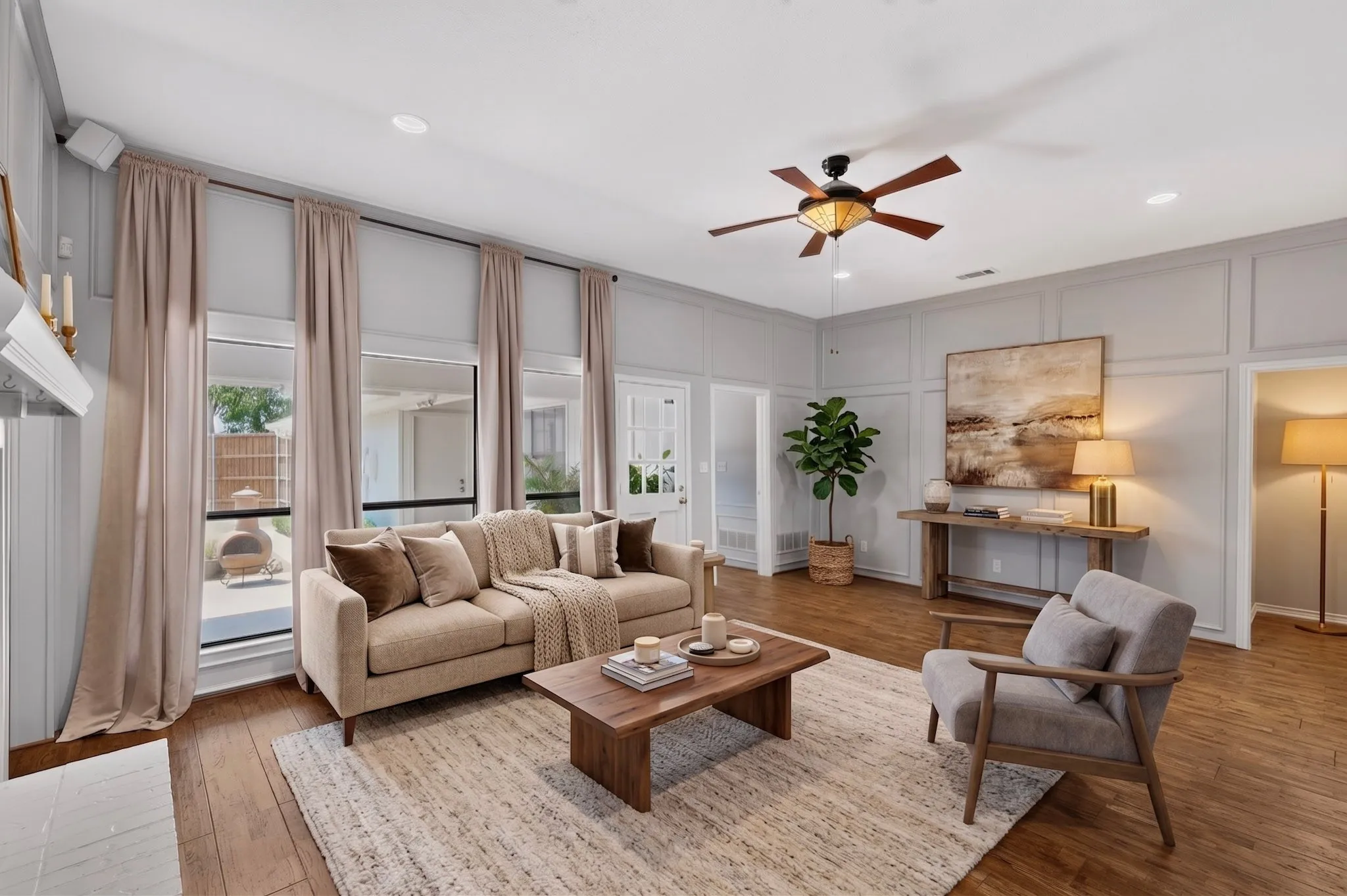 Living area featuring wood-finish flooring, recessed lighting, a ceiling fan, and panel molding on the walls