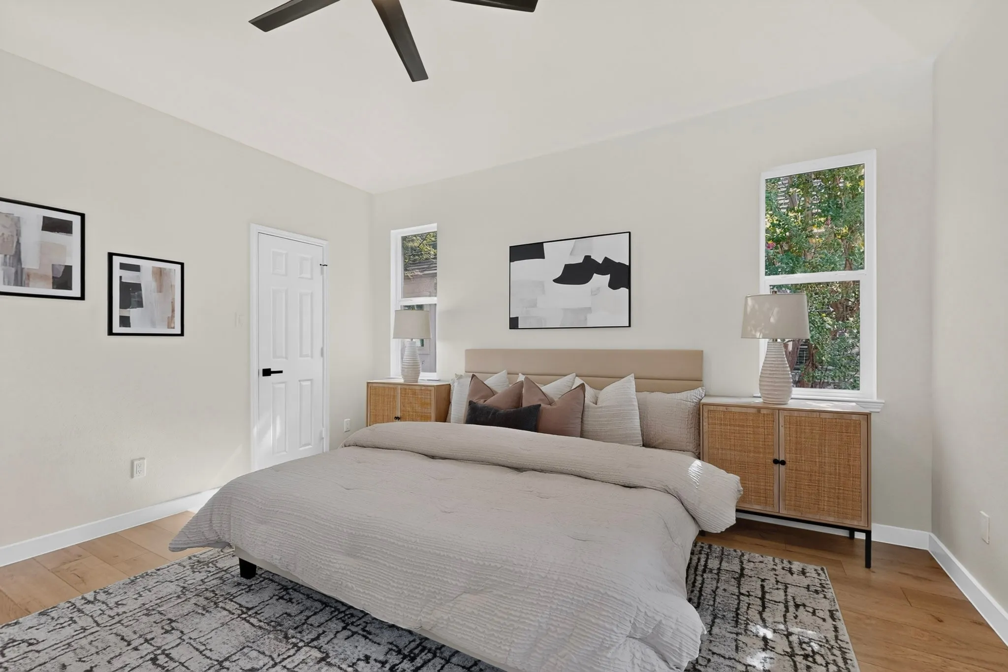 Light wood-finish flooring, recessed windows, and a ceiling fan with integrated lighting
