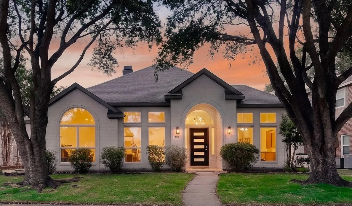 White brick exterior with dark trim and a dark shingle roof