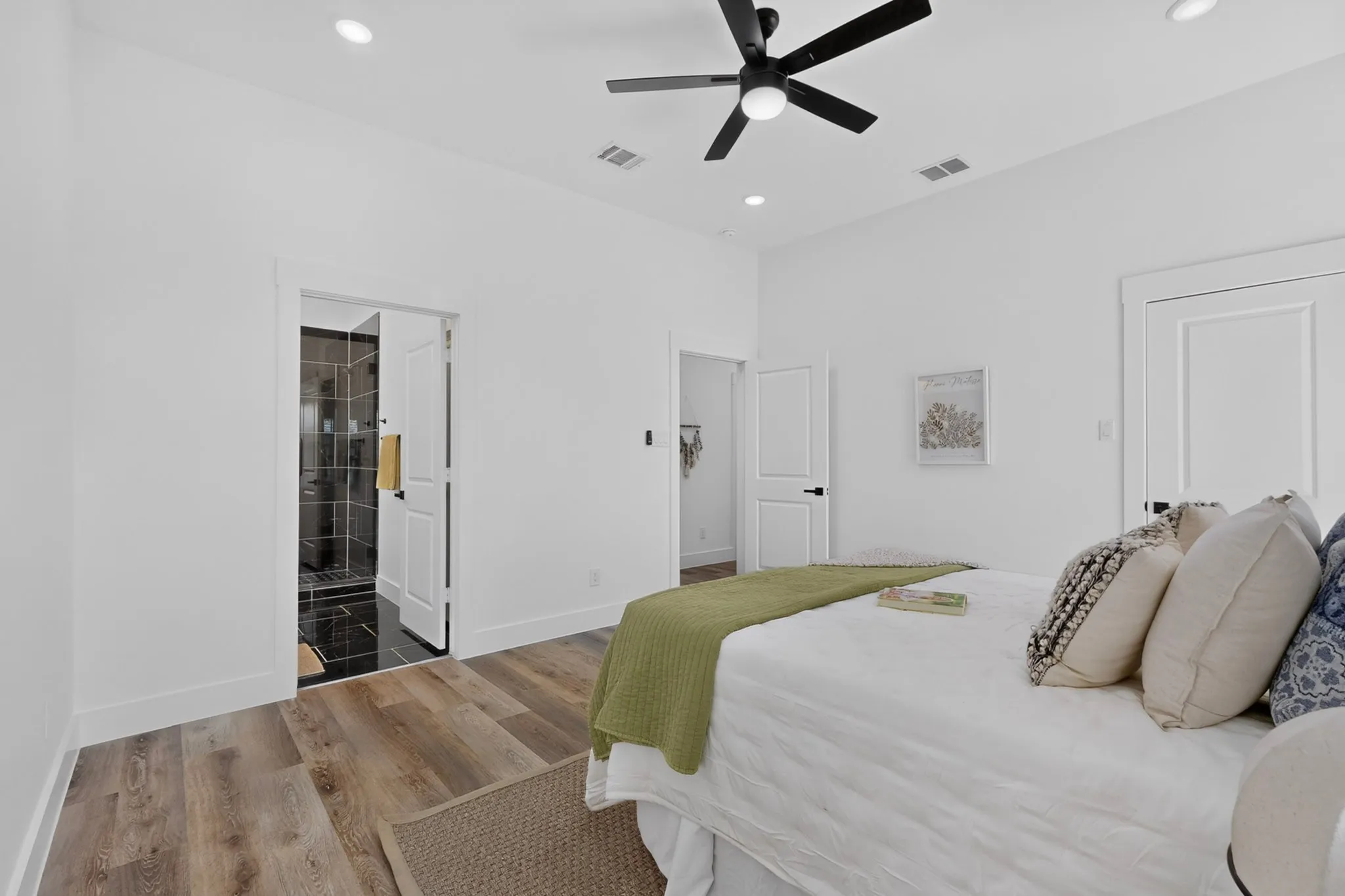 Wood-finish flooring, recessed lighting, and a contemporary ceiling fan