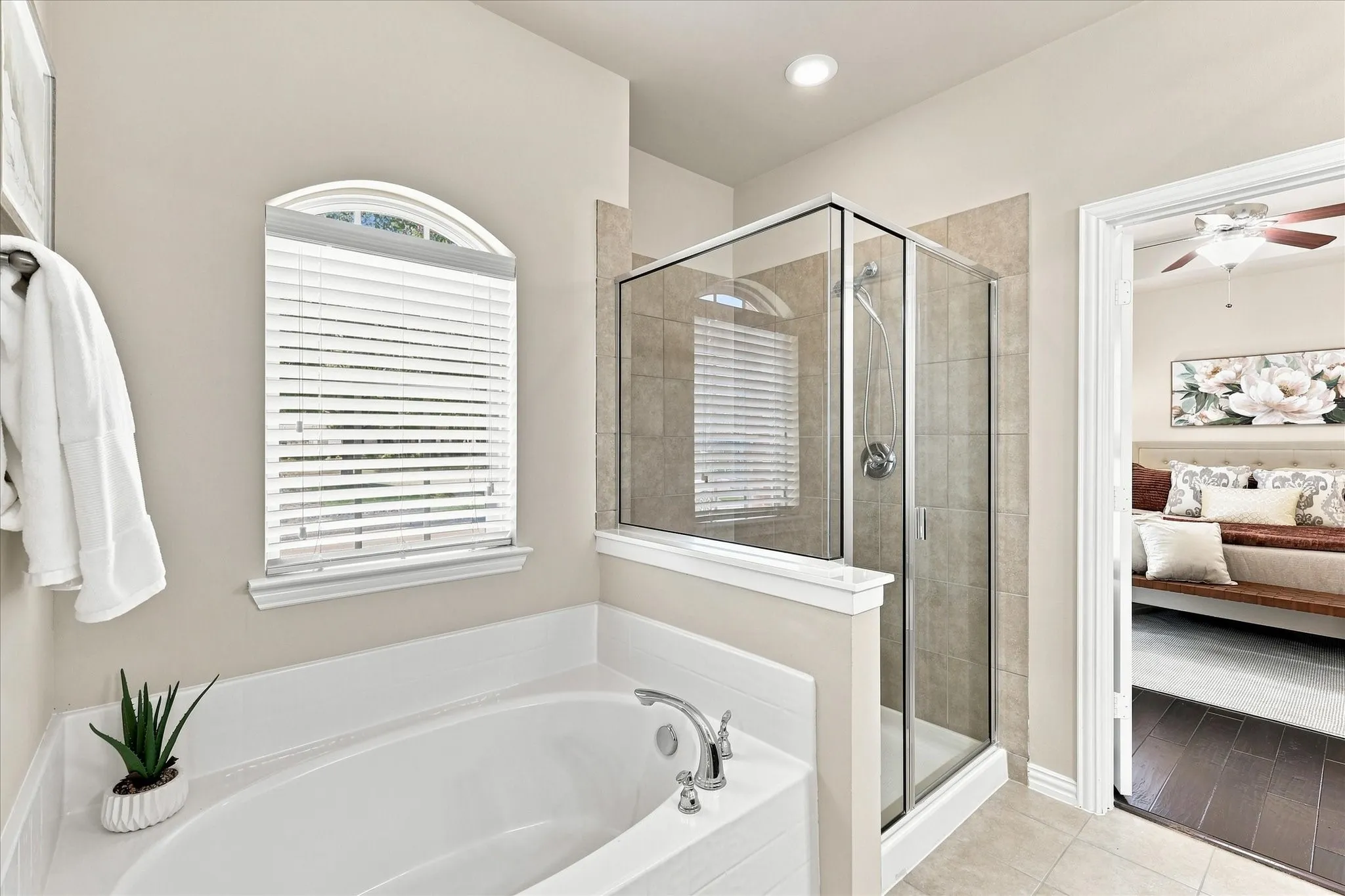 The primary bathroom features a garden tub and separate shower, creating a comfortable space to start and end the day.
