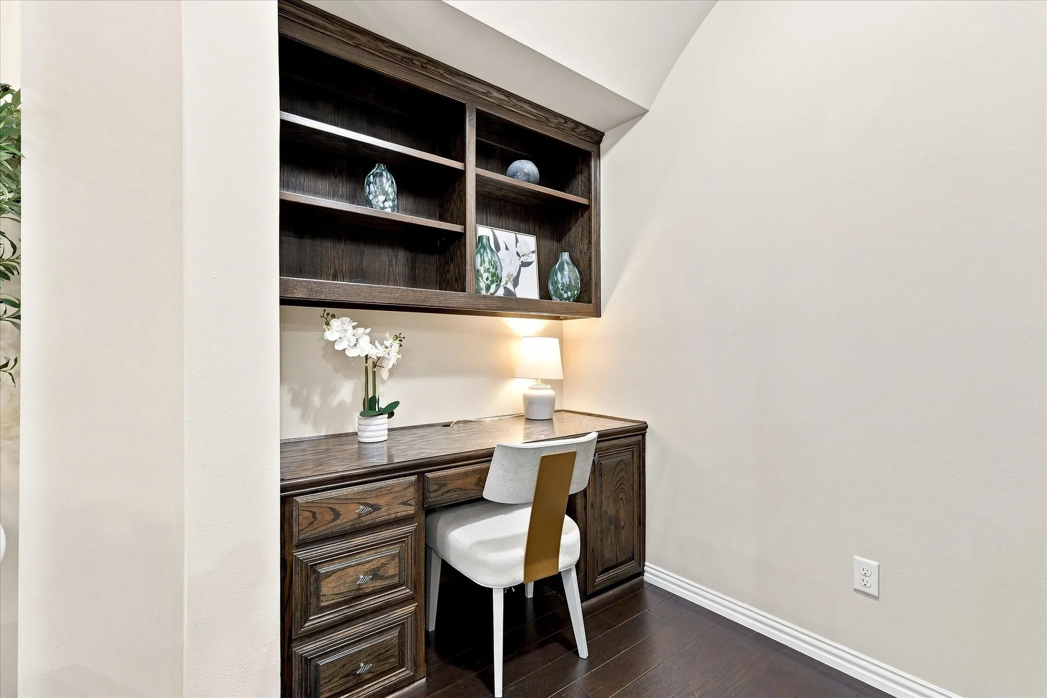 Just off the kitchen, a versatile flex space with built-in cabinetry and a desk offers the perfect spot for working from home, managing household paperwork, paying bills, or creating a convenient home command center.