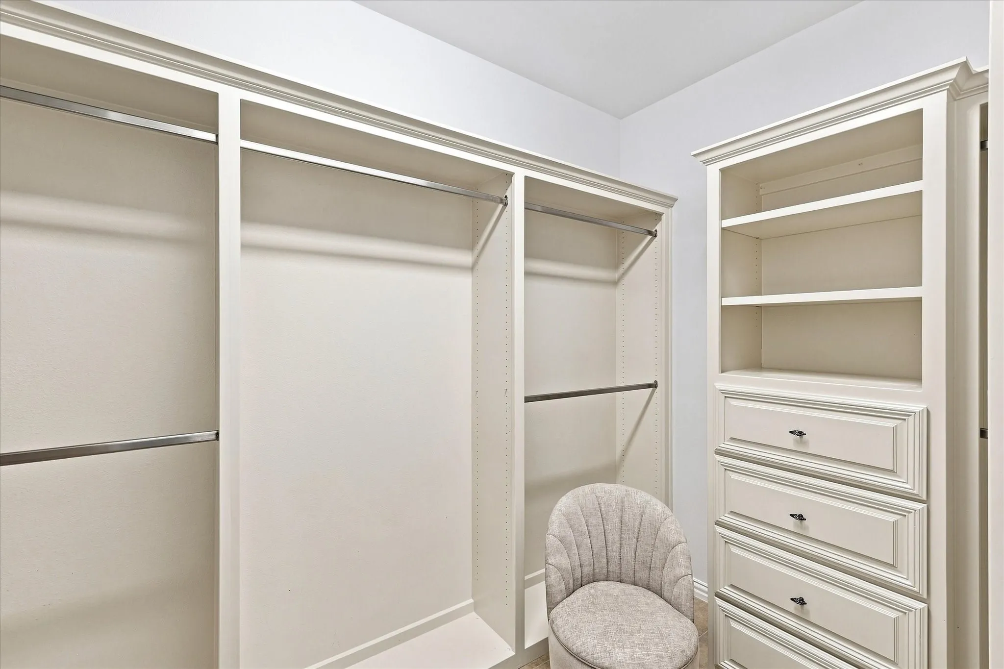 The spacious walk-in primary closet features built-in cabinetry, providing exceptional storage and an organized place for everything.