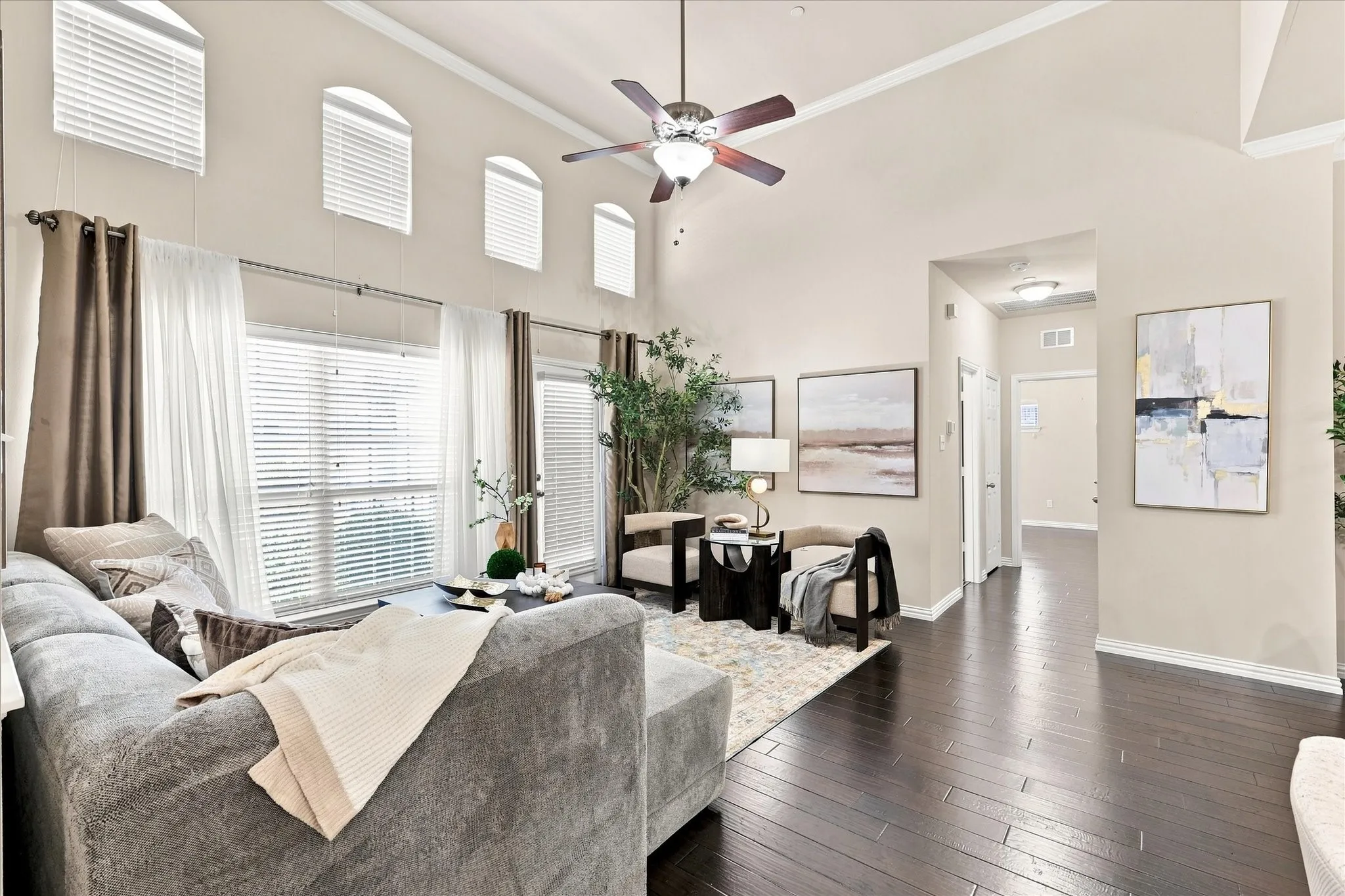 The spacious, light-filled living room offers a comfortable gathering space with an open feel and plenty of natural light.