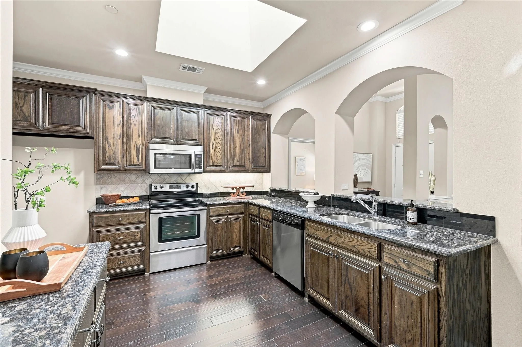 Granite countertops and stainless steel appliances add a polished touch to the kitchen.