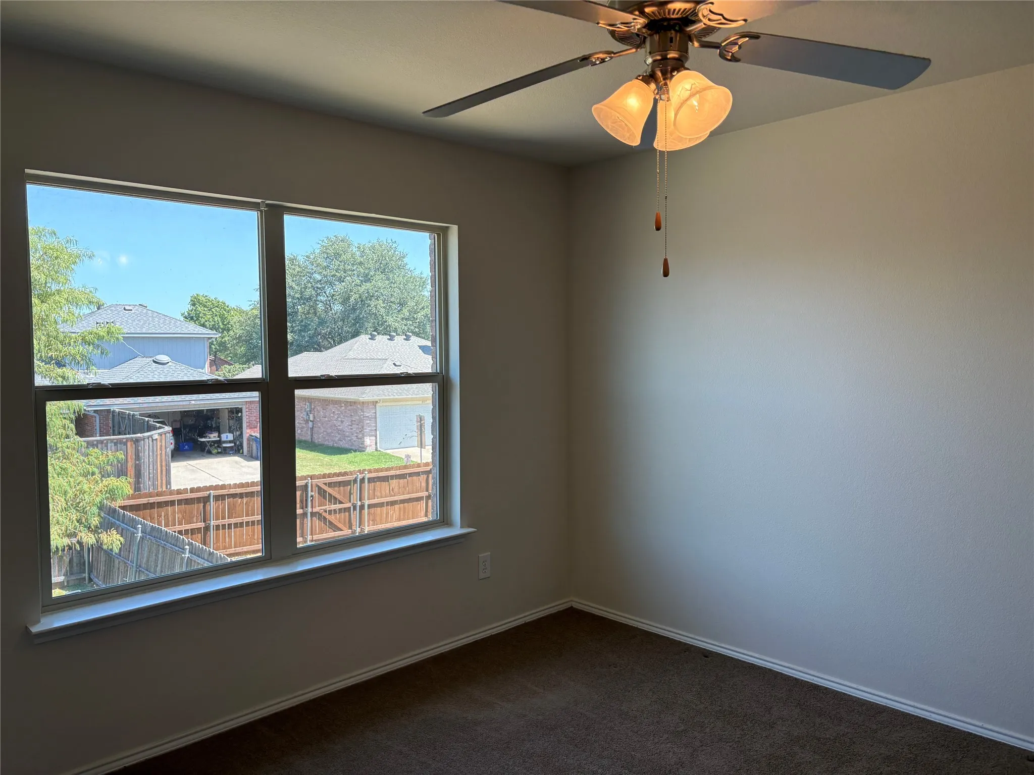 with ceiling fan and view of the outside