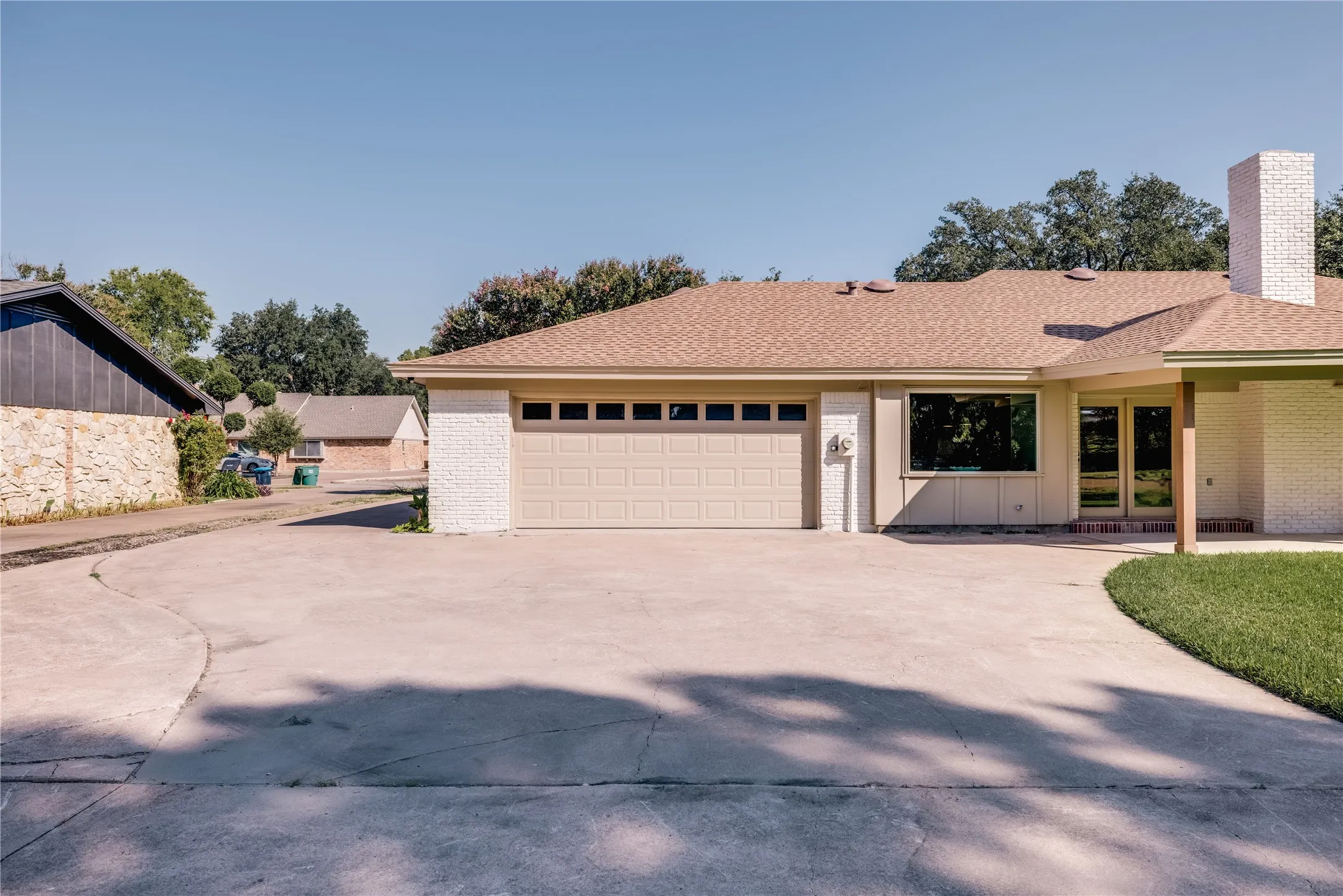 Oversized concrete driveway with a two-car garage