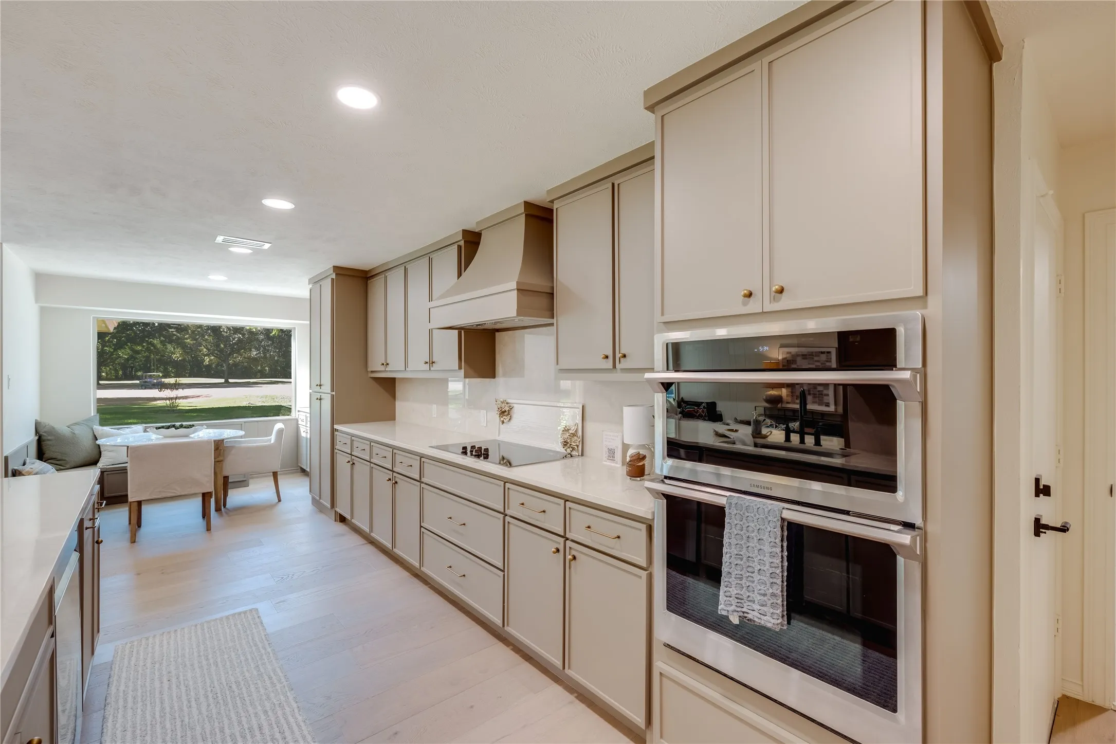 Kitchen featuring white countertops, built-in stainless steel double ovens, and a built-in cooktop