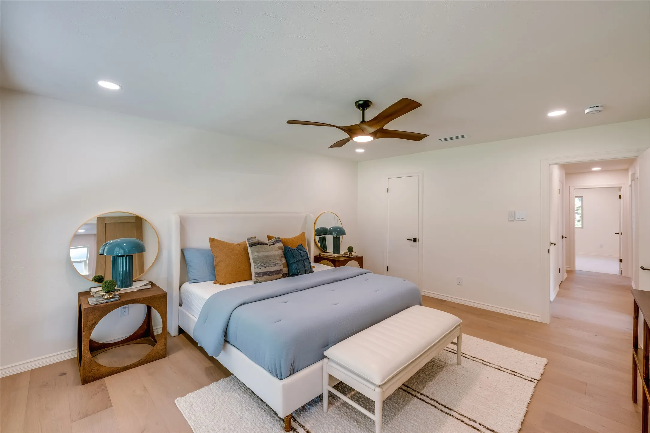 Bedroom featuring light wood-finish flooring, recessed lighting, and a contemporary ceiling fan