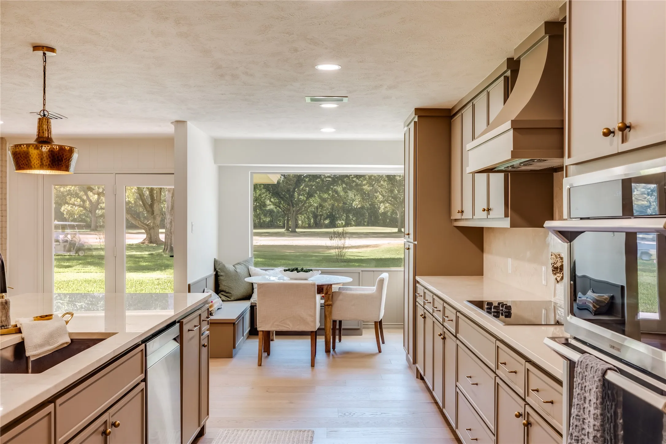 Kitchen featuring light wood-finish flooring, recessed lighting, and a contemporary pendant light fixture