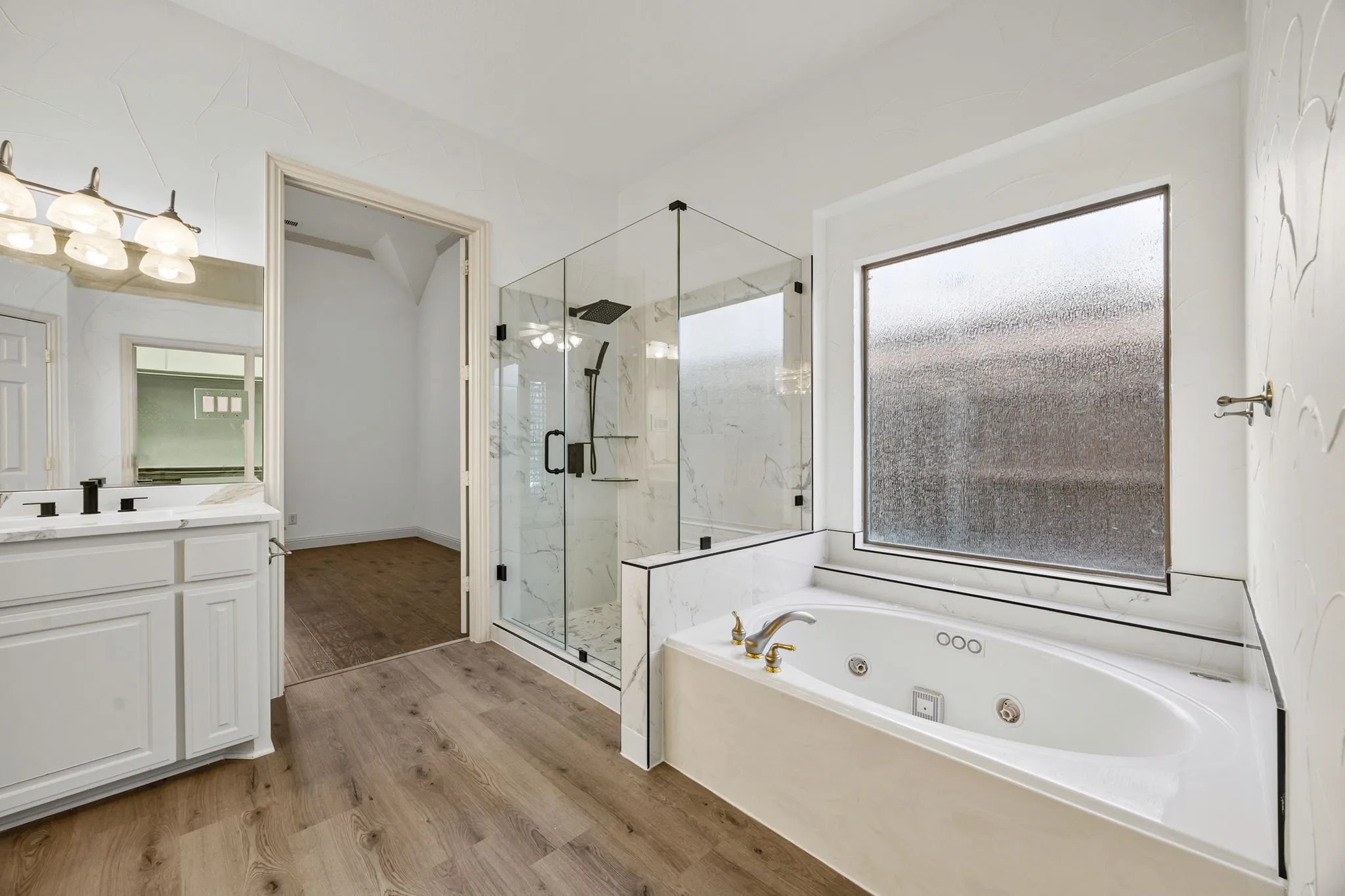 Master bathroom with expanded walk-in frameless door shower