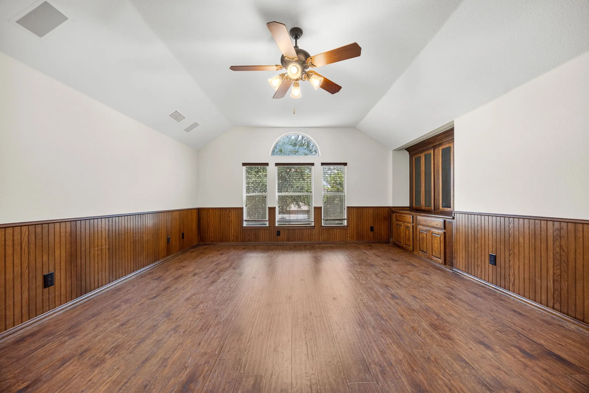 Game room overlooking back yard trees
