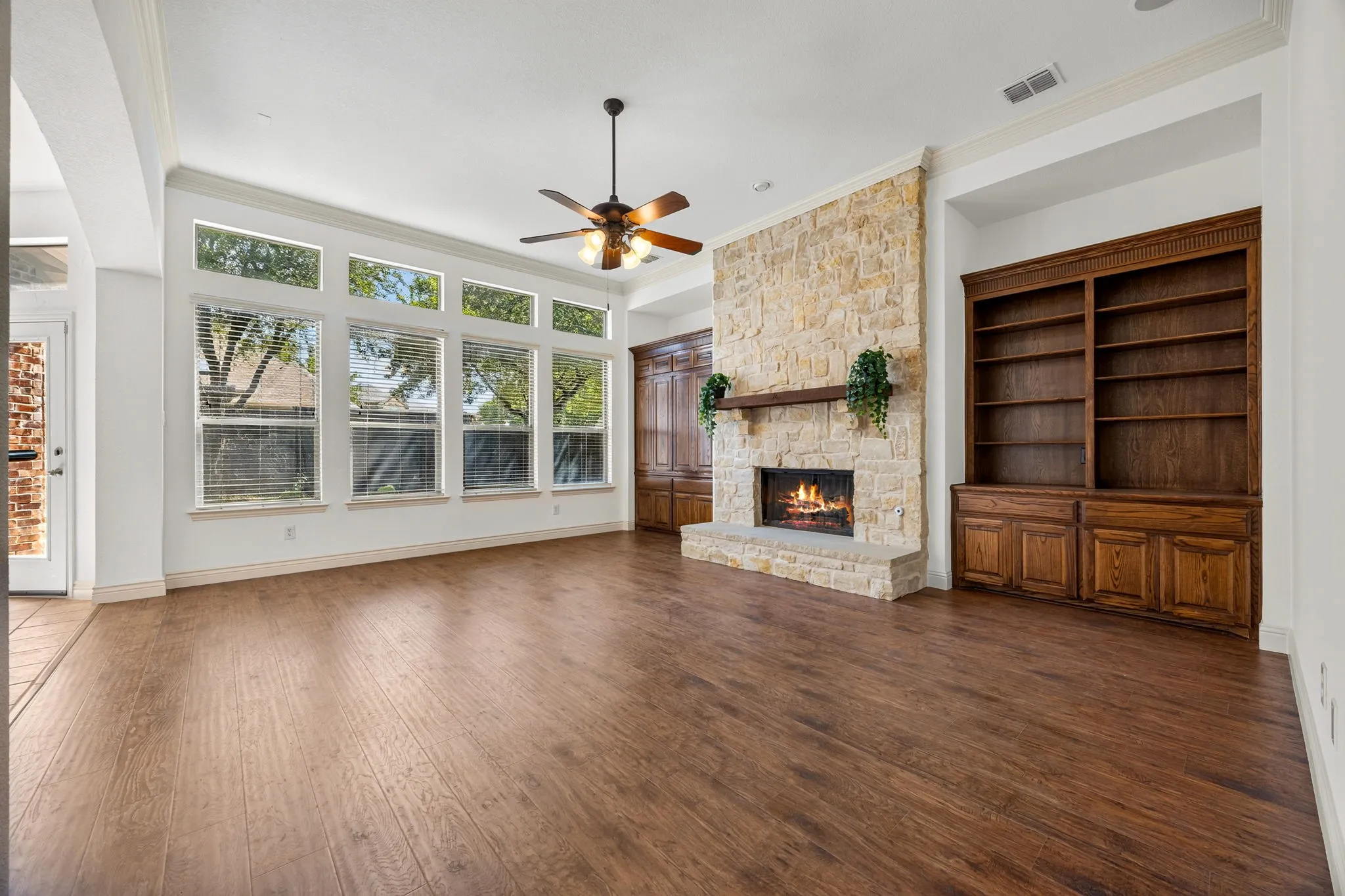  family room overlooking a tranquil, private backyard with a lush lawn and mature trees