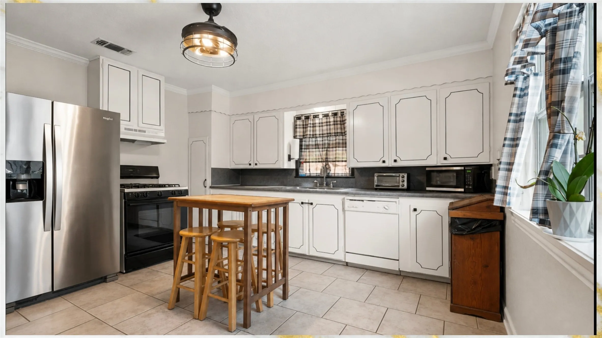 White cabinetry with black trim, stainless steel side-by-side refrigerator, black range, white dishwasher, and tiled flooring