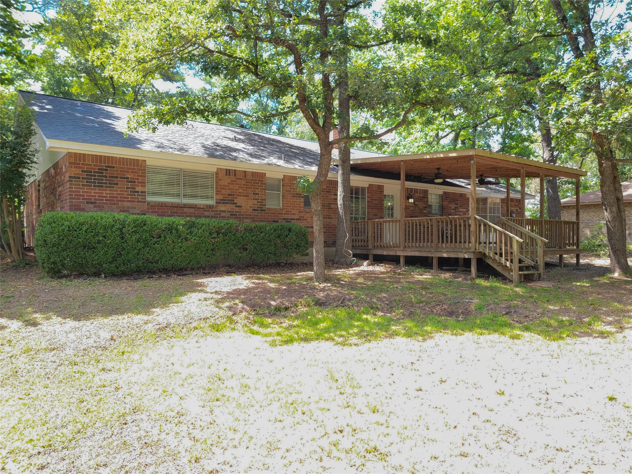 Brick exterior with a covered wood deck