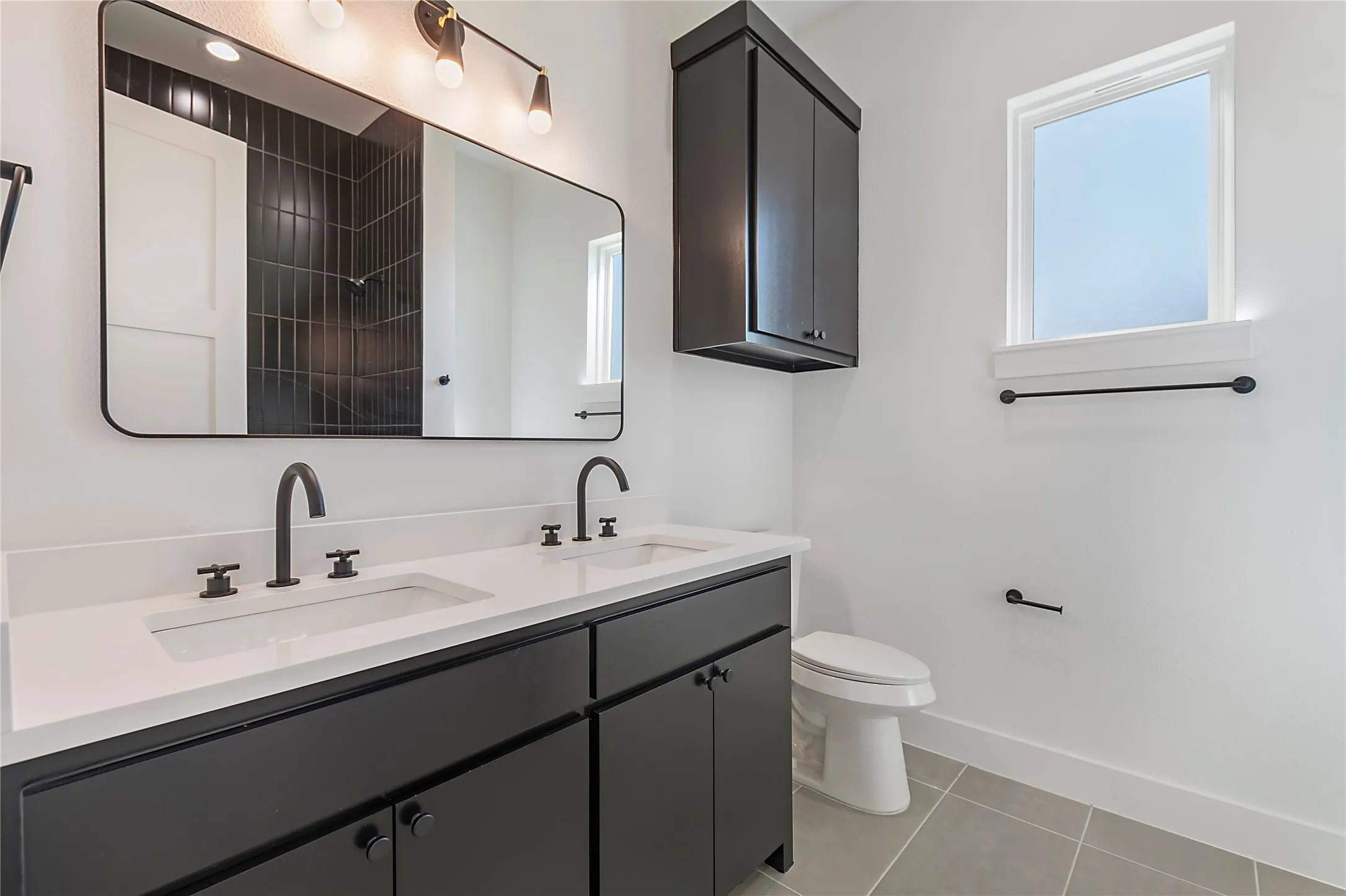 Dual vanity with white countertops and matte black hardware