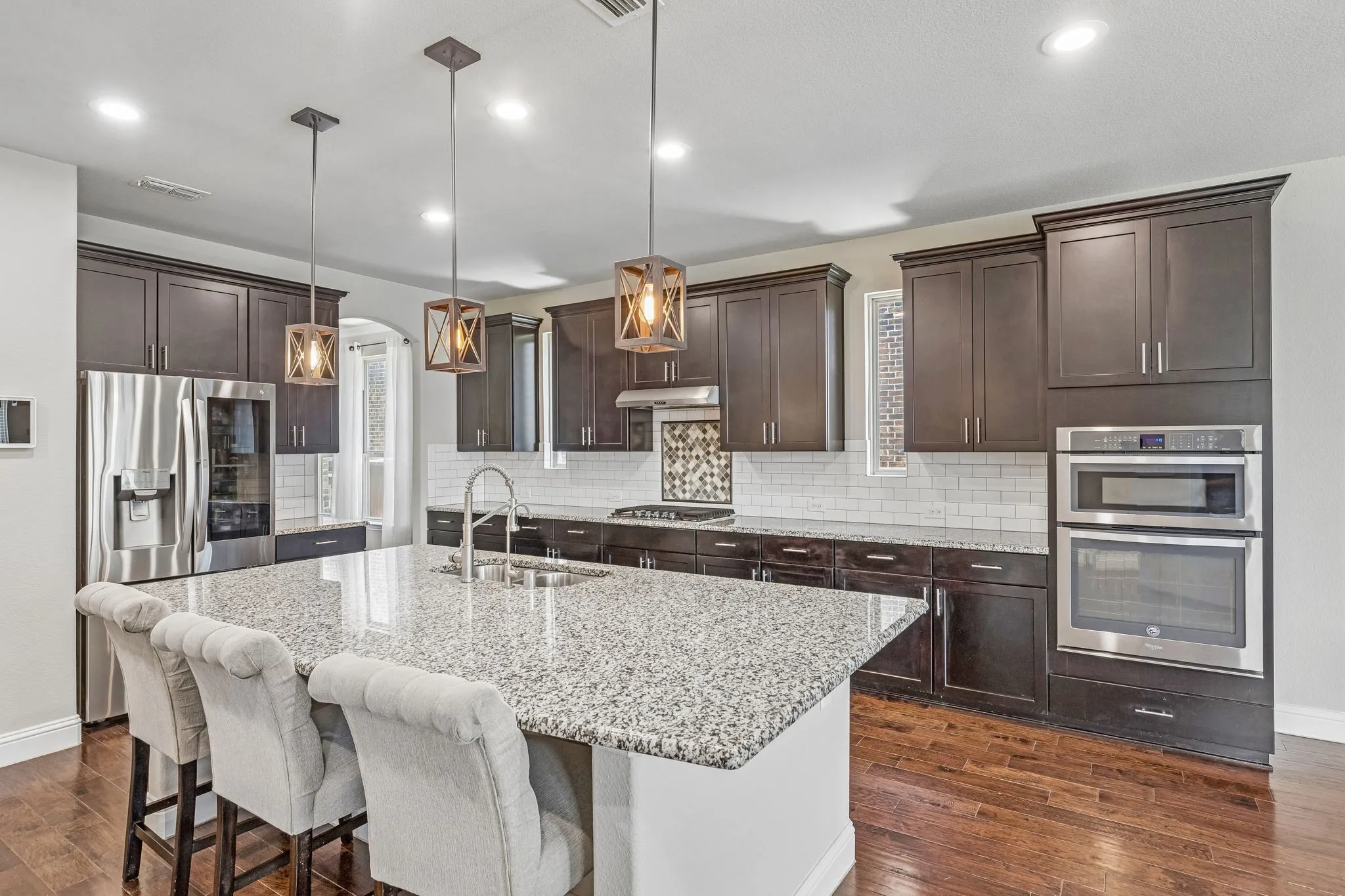 The kitchen features stainless steel appliances including an over and built-in microwave