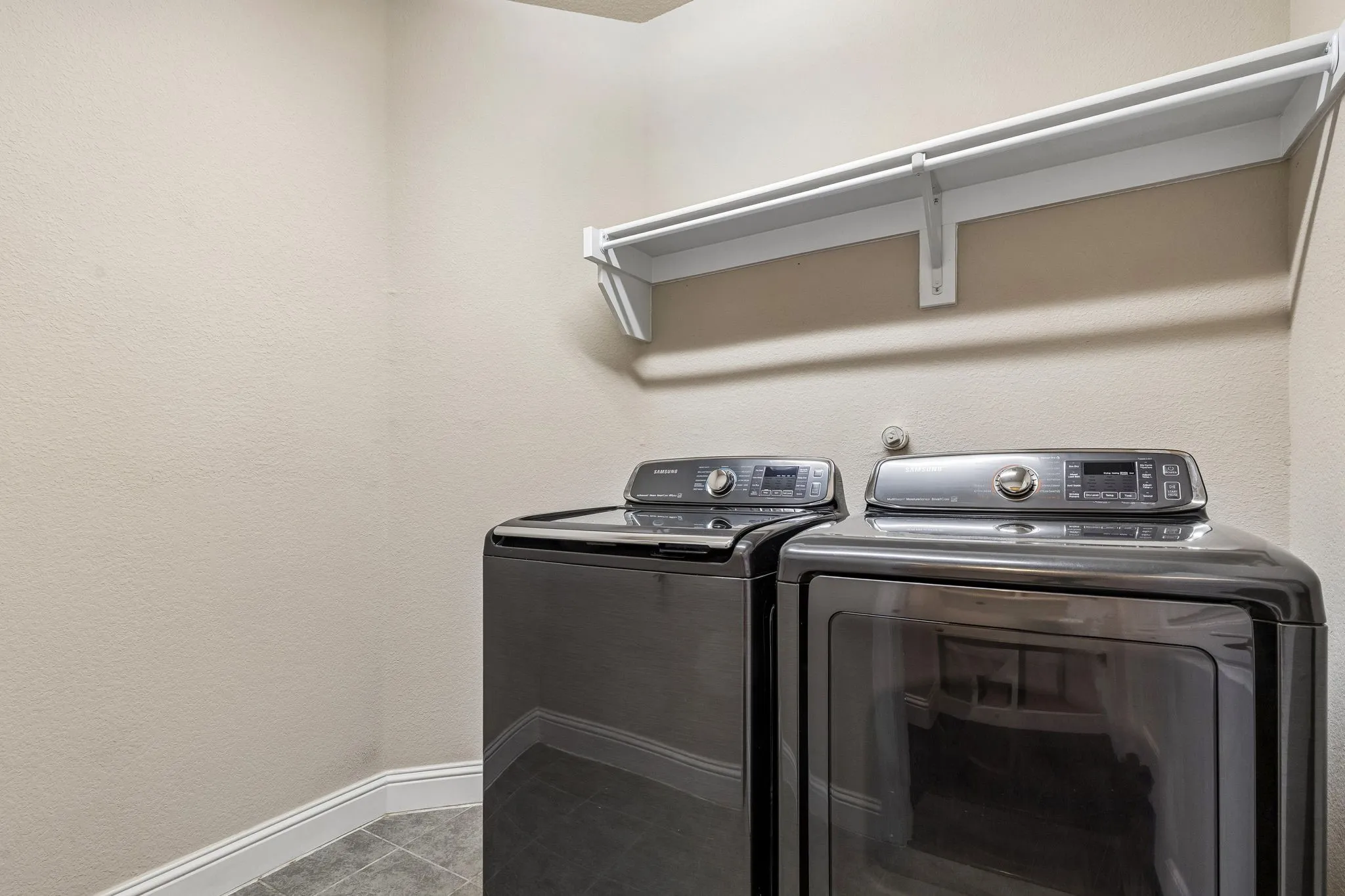 Laundry room featuring open storage