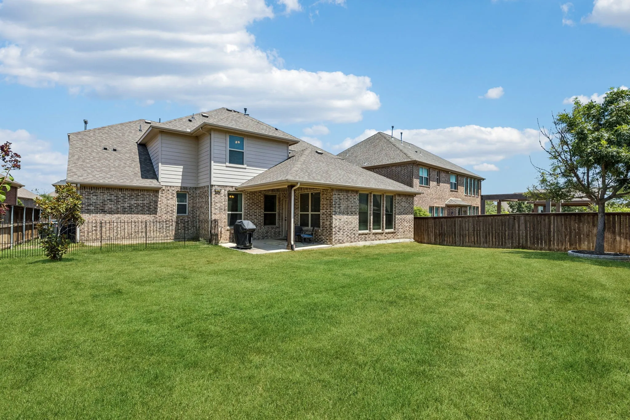 Large backyard with a dog run area on the left.