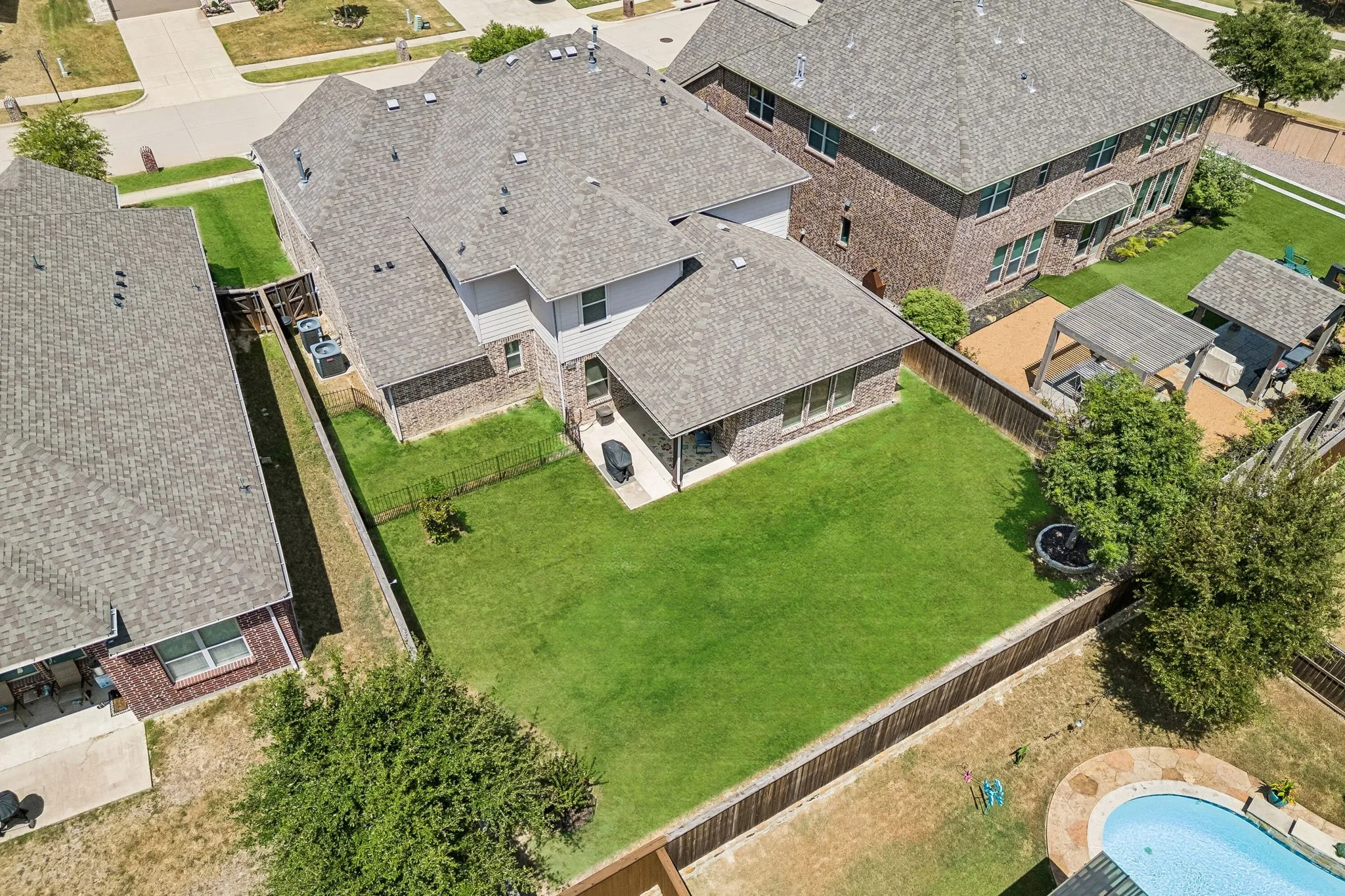 Aerial view of the back of the home and the backyard