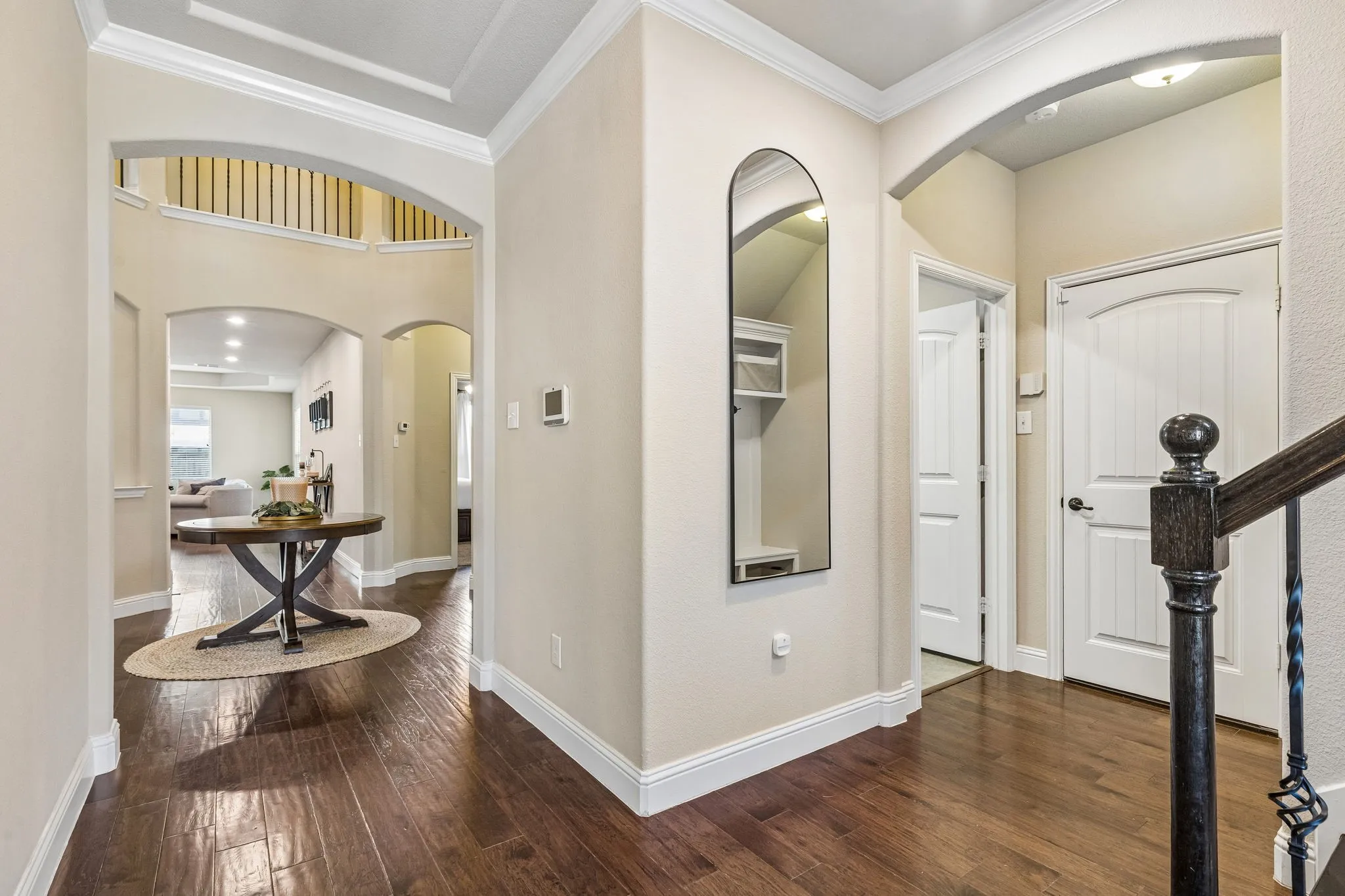 You are greeted by arched doorways and crown molding in the front entry
