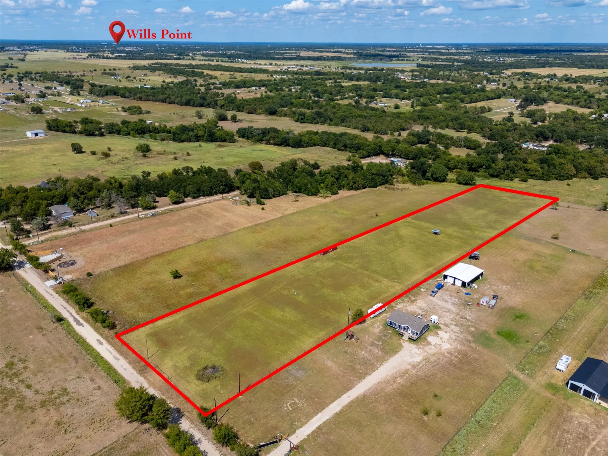 Expansive rectangular lot featuring a large open field and mature trees along the perimeter