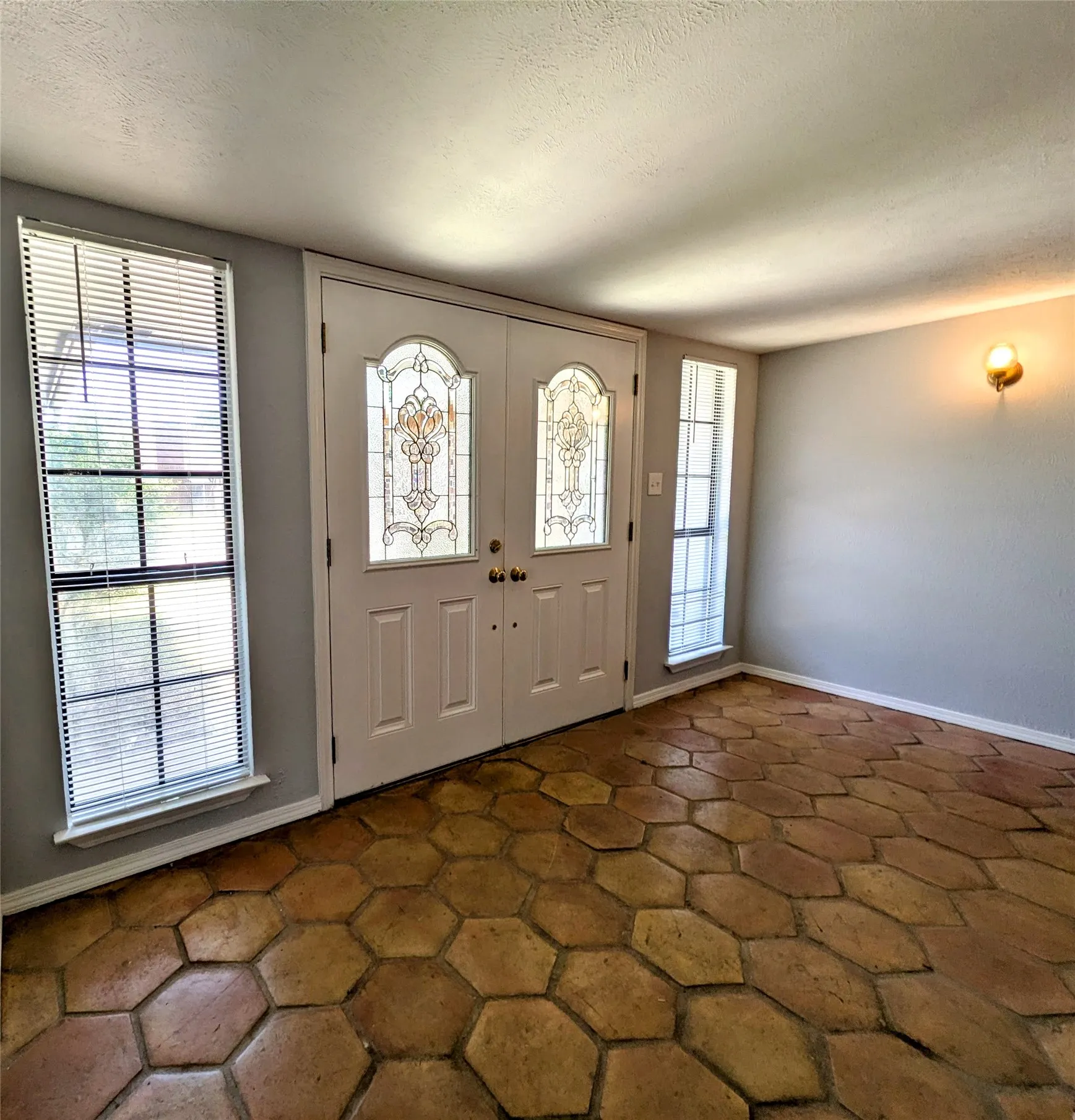 Double entry doors with decorative glass panels